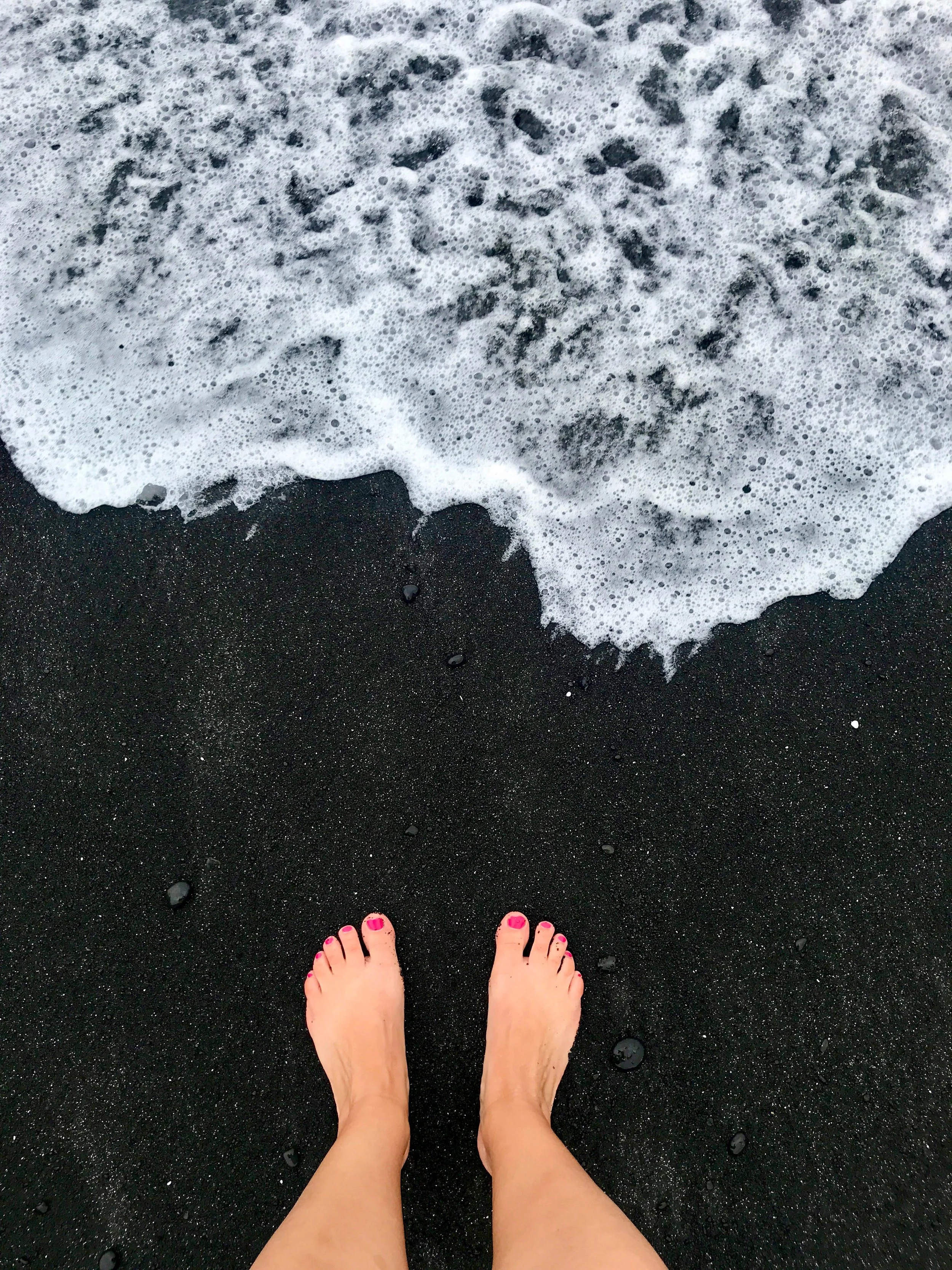 Standing on the black sand beach at Wai'anapanapa State Park in Maui, Hawaii
