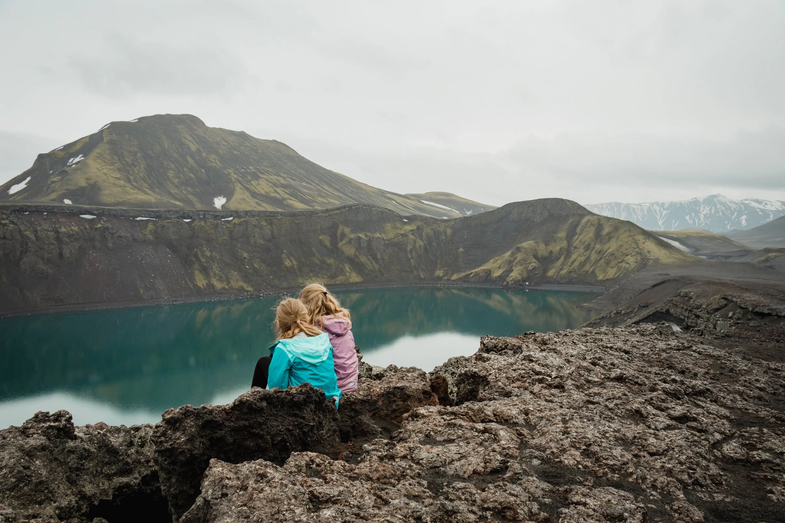 Two girls looking at Ljótipollu Crater in Iceland