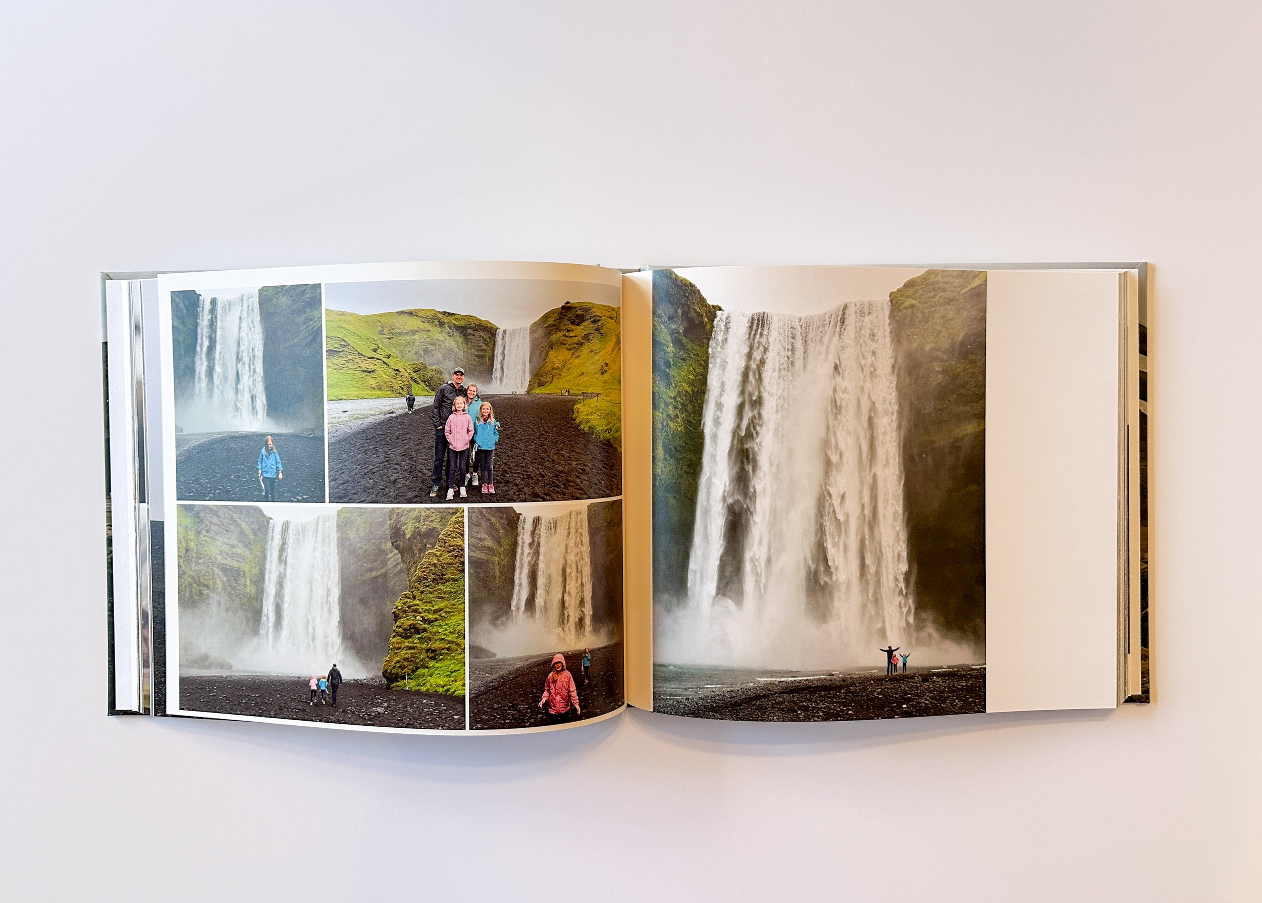 Open photo album showing pictures of a waterfall and visitors in a scenic landscape.
