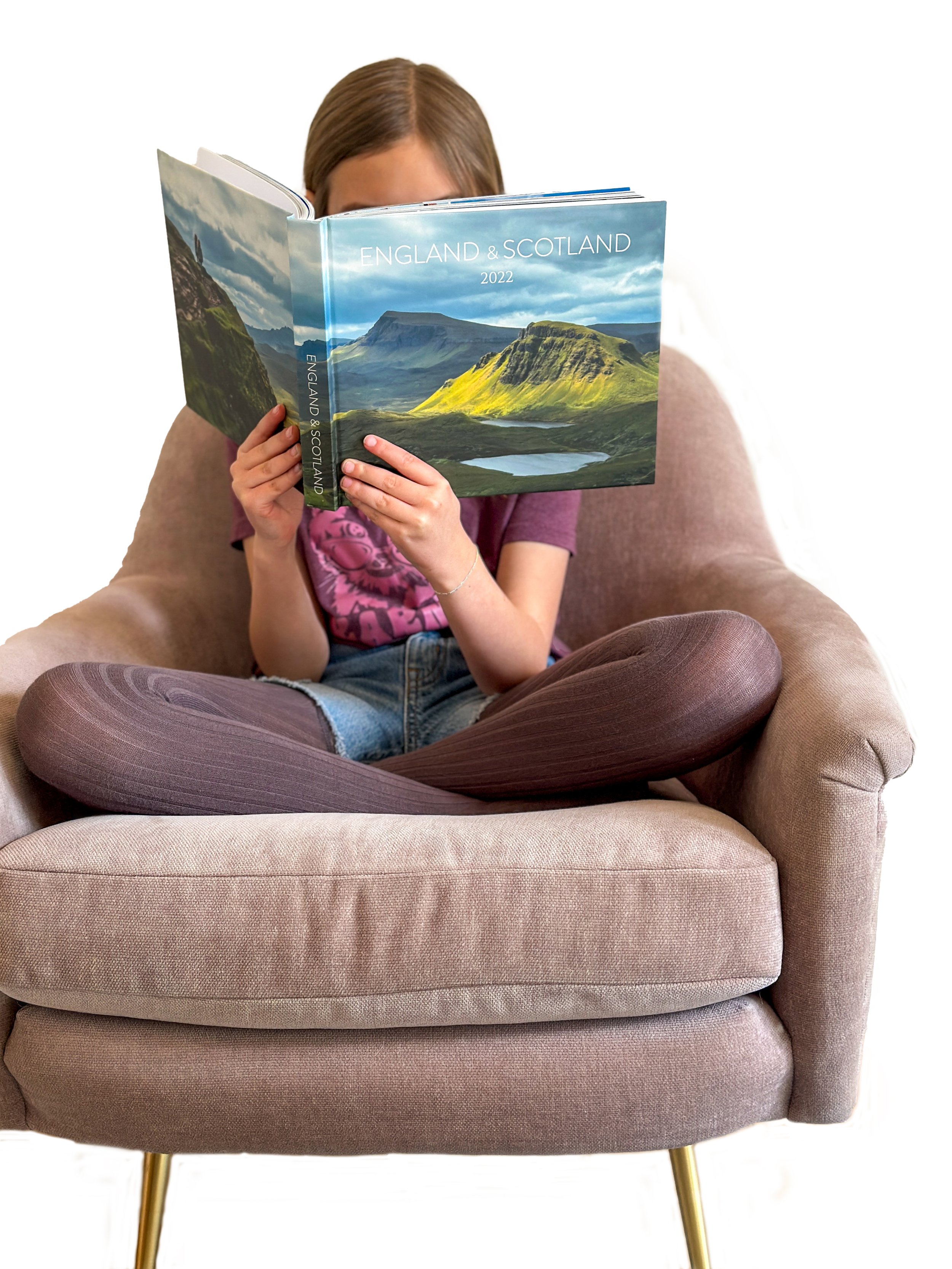 girl reading custom photo book of a vacation to the UK
