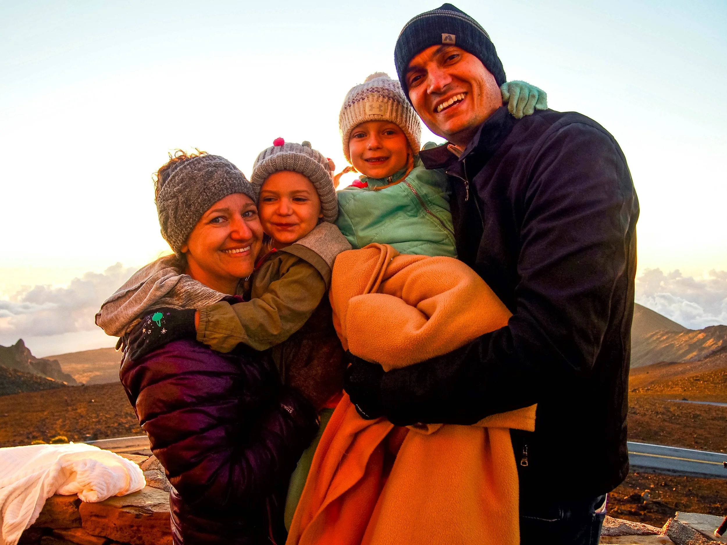 Family at sunrise at the top of Haleakala National Park in Maui, Hawaii