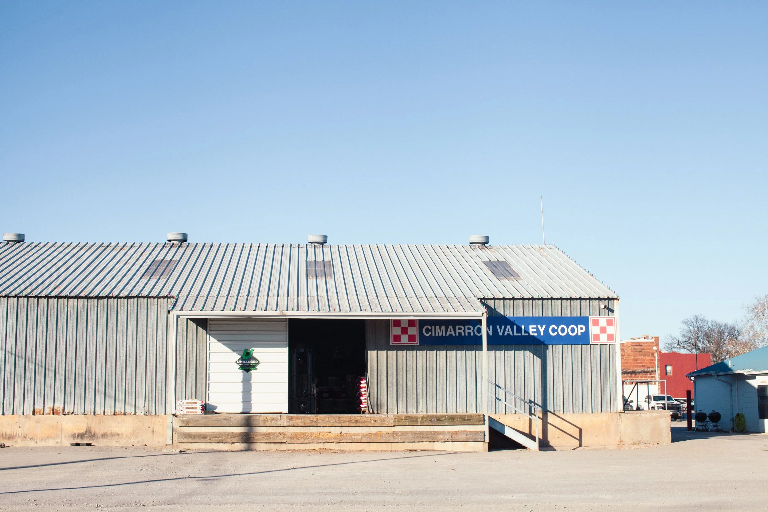 Co-op warehouse stocked with bagged livestock feed at Cimarron Valley Co-op in Perkins, Oklahoma.