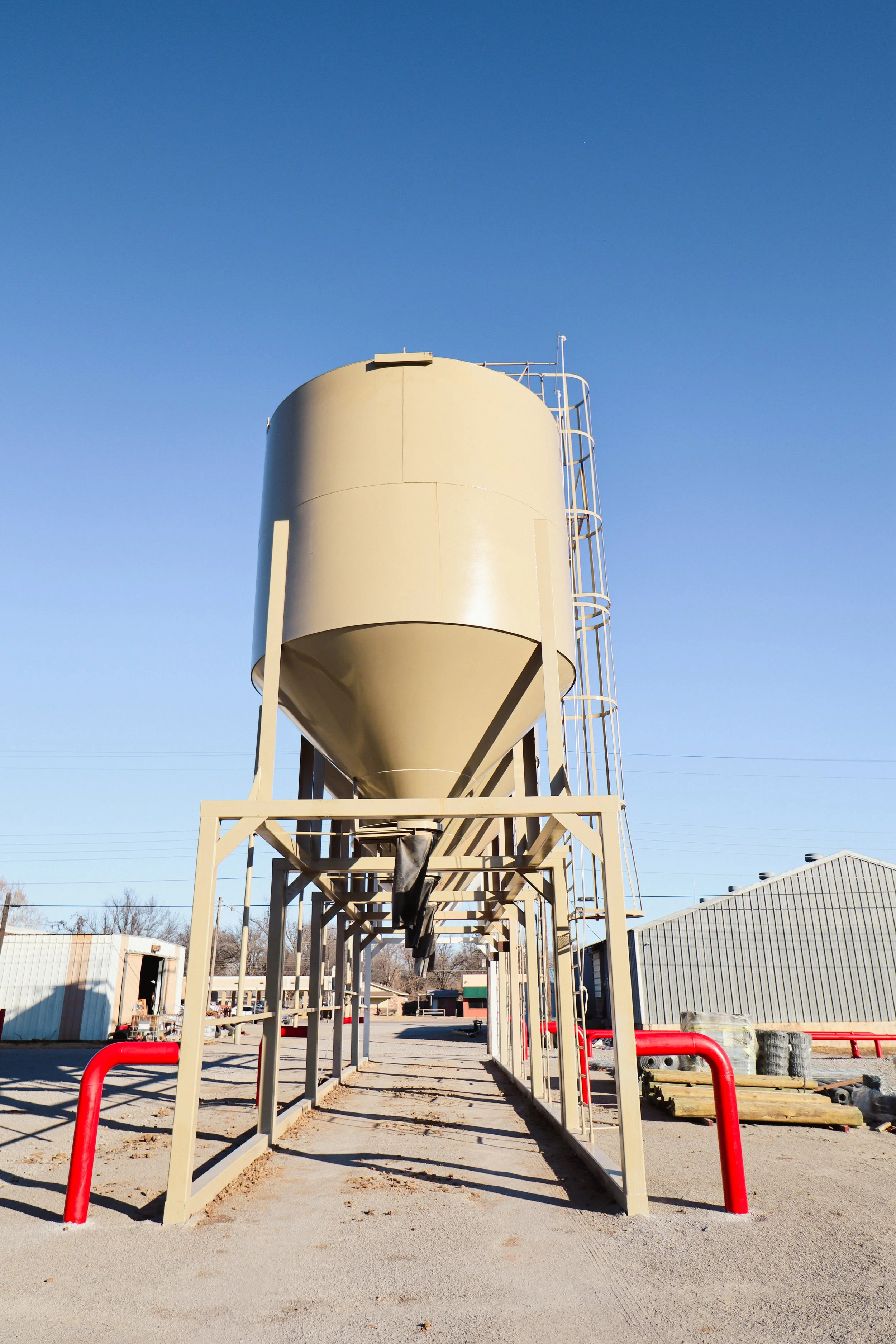 Bulk feed bins used for storing and dispensing livestock feed for daily feeding operations.