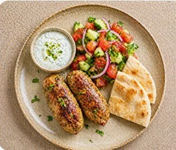 Chicken kofta with cucumber tomato salad and pita.jpg