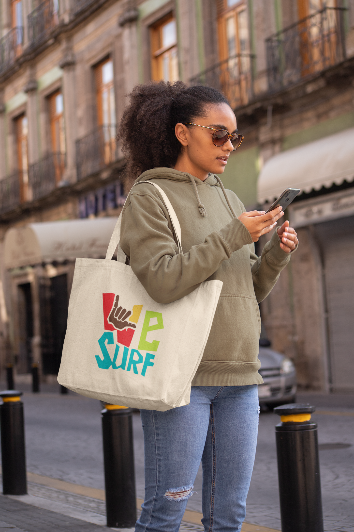 tote-bag-mockup-of-a-woman-in-the-street-checking-her-phone-28848.png