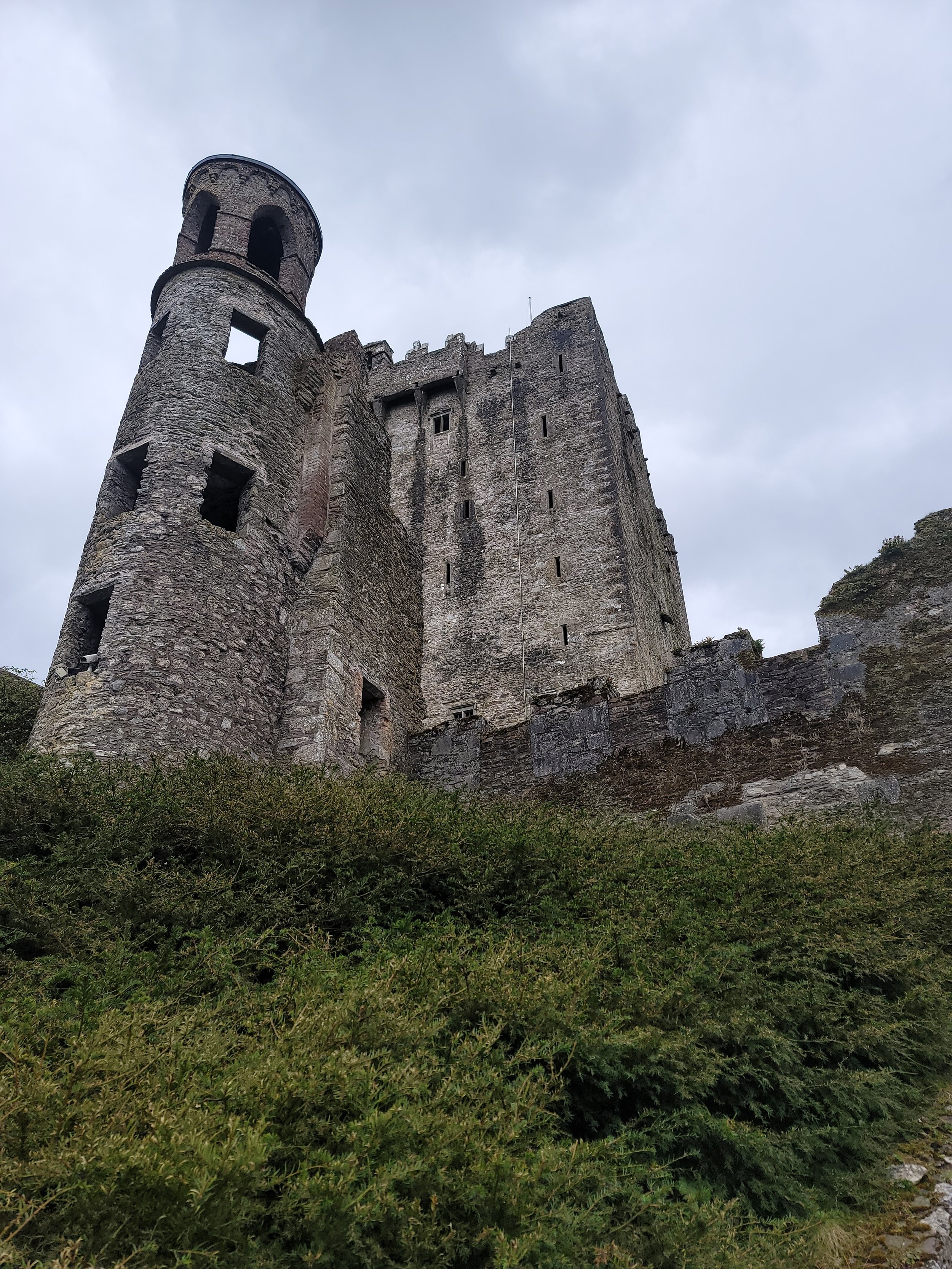 Ancient castle ruins on a green hillside in Ireland on a custom Ireland and Europe itinerary.
