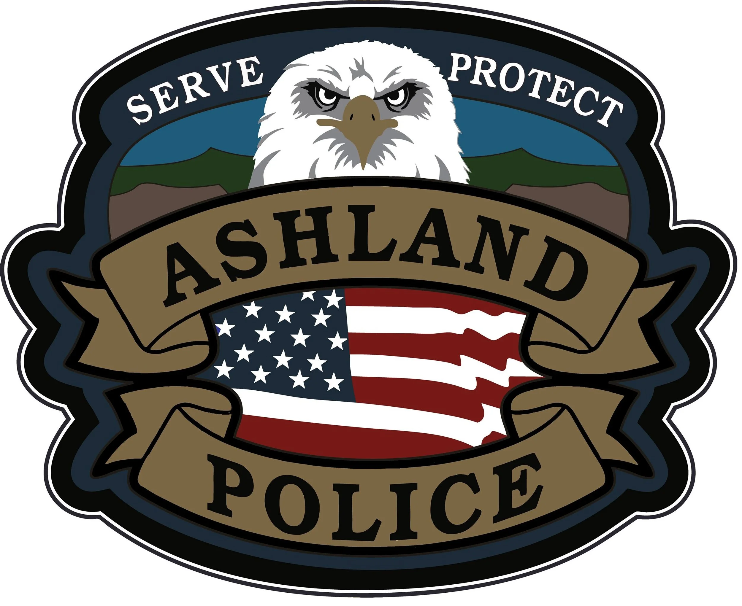 Badge with an eagle, mountains, an American flag, and the words 'Serve,' 'Protect,' 'Ashland,' and 'Police'.