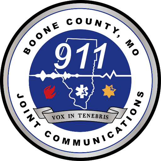 Emblem for Boone County, Missouri Joint Communications showing 911 and fire, medical symbols, and the phrase 'Vox in Tenebris'.