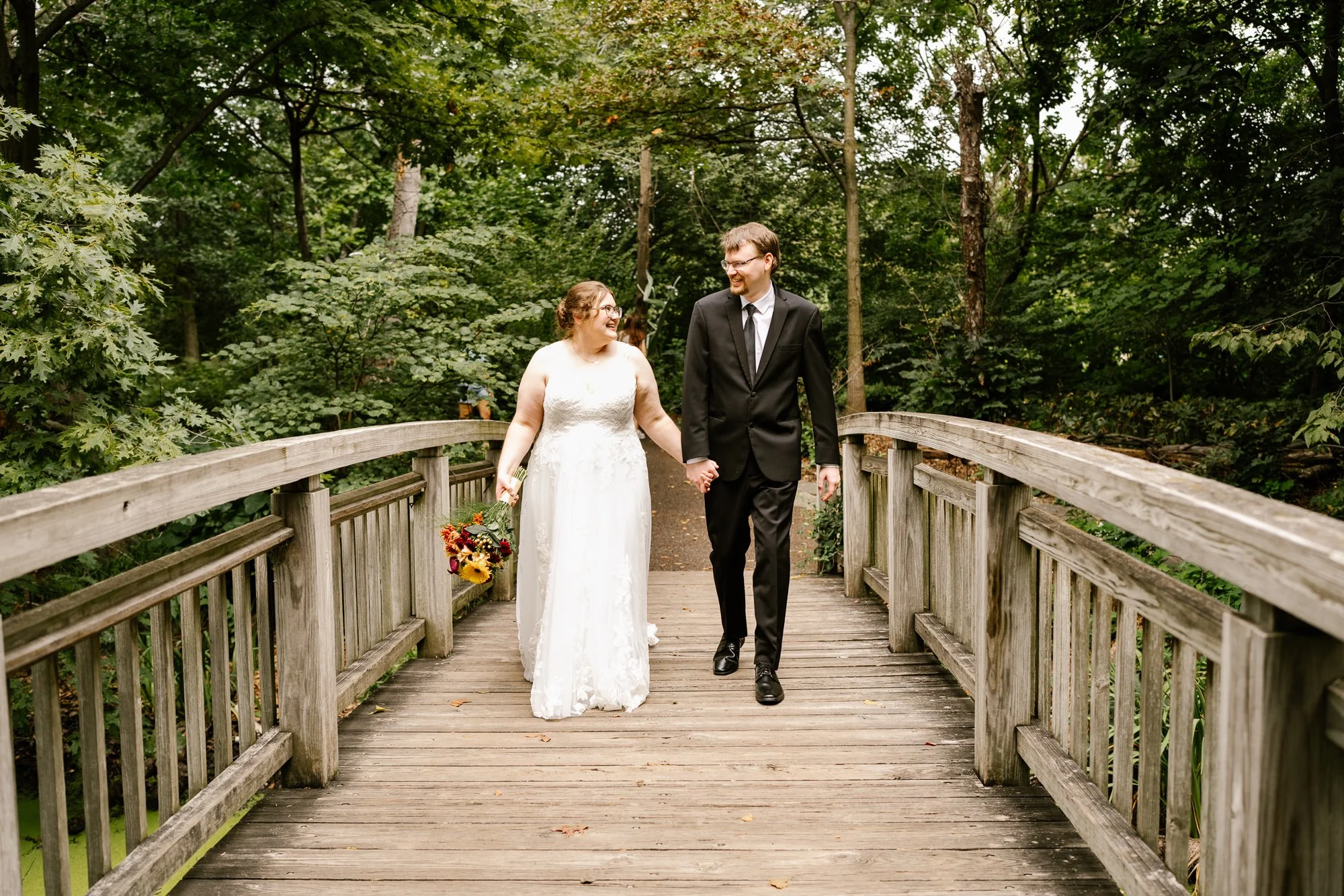 Bride and groom exploring Olbrich Botanical Gardens on their wedding day