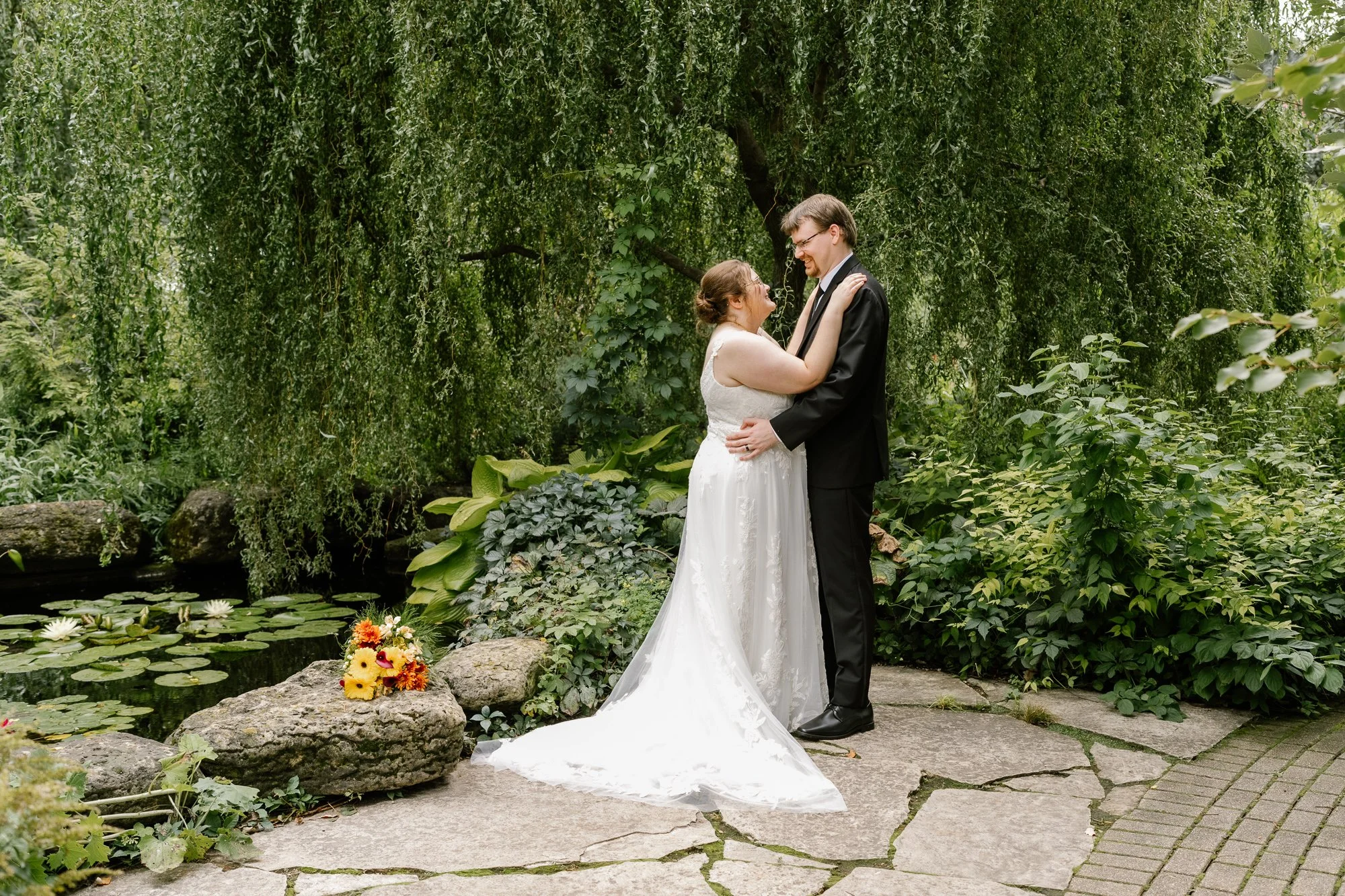 Bride and groom surrounded by lush gardens at Olbrich Botanical Gardens