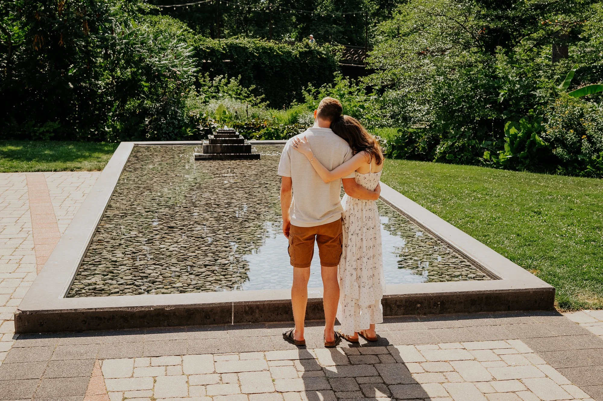 engaged couple looking at Japanese rock garden in madison