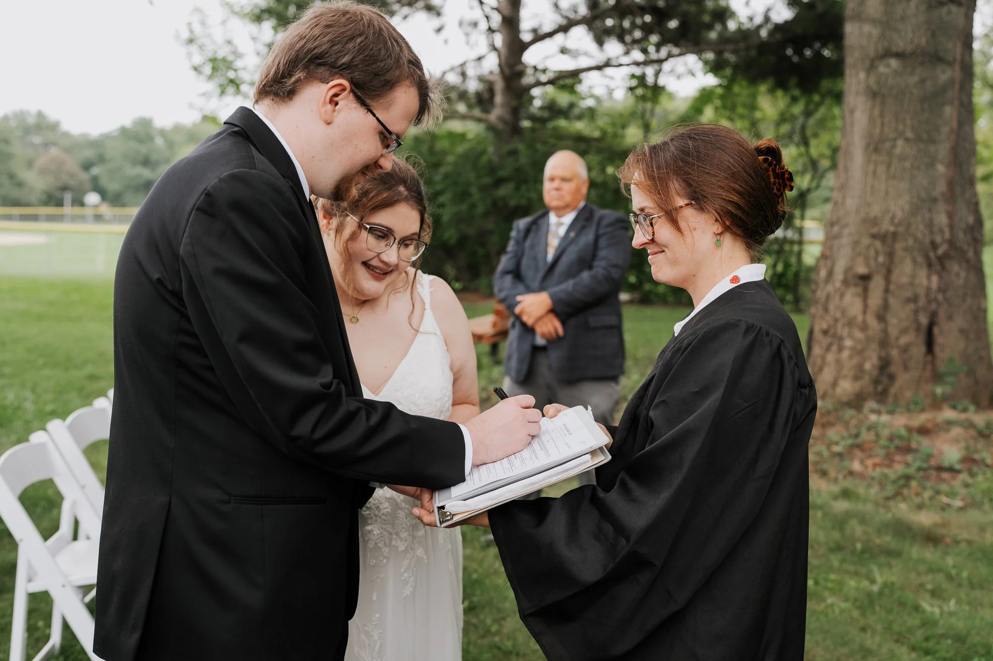Groom signing marriage license at Madison intimate wedding
