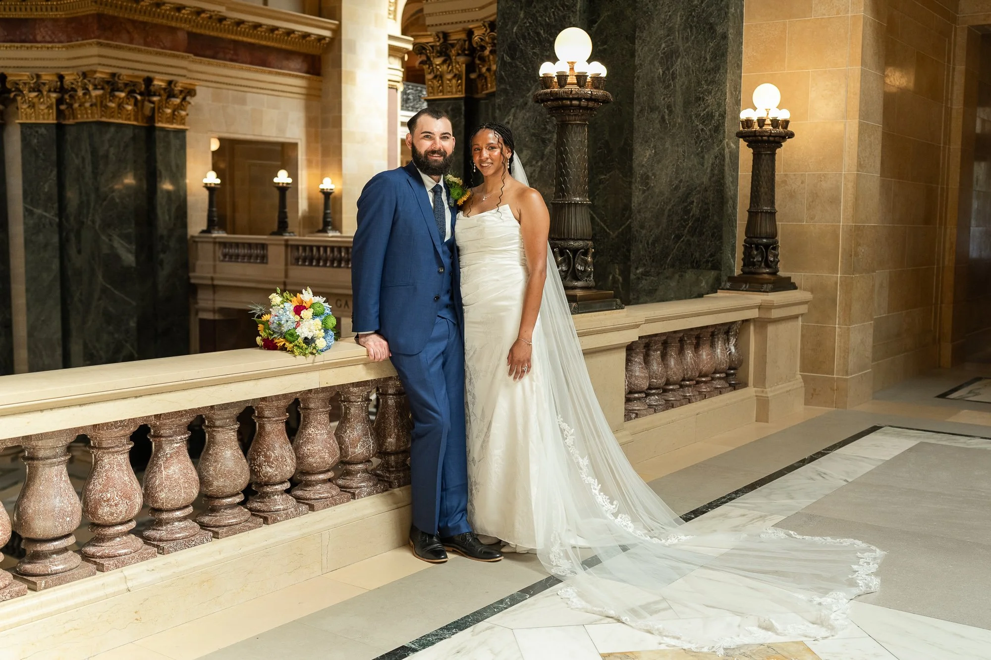 Newlywed couple posing for portraits inside the Wisconsin State Capitol during their Madison elopement.