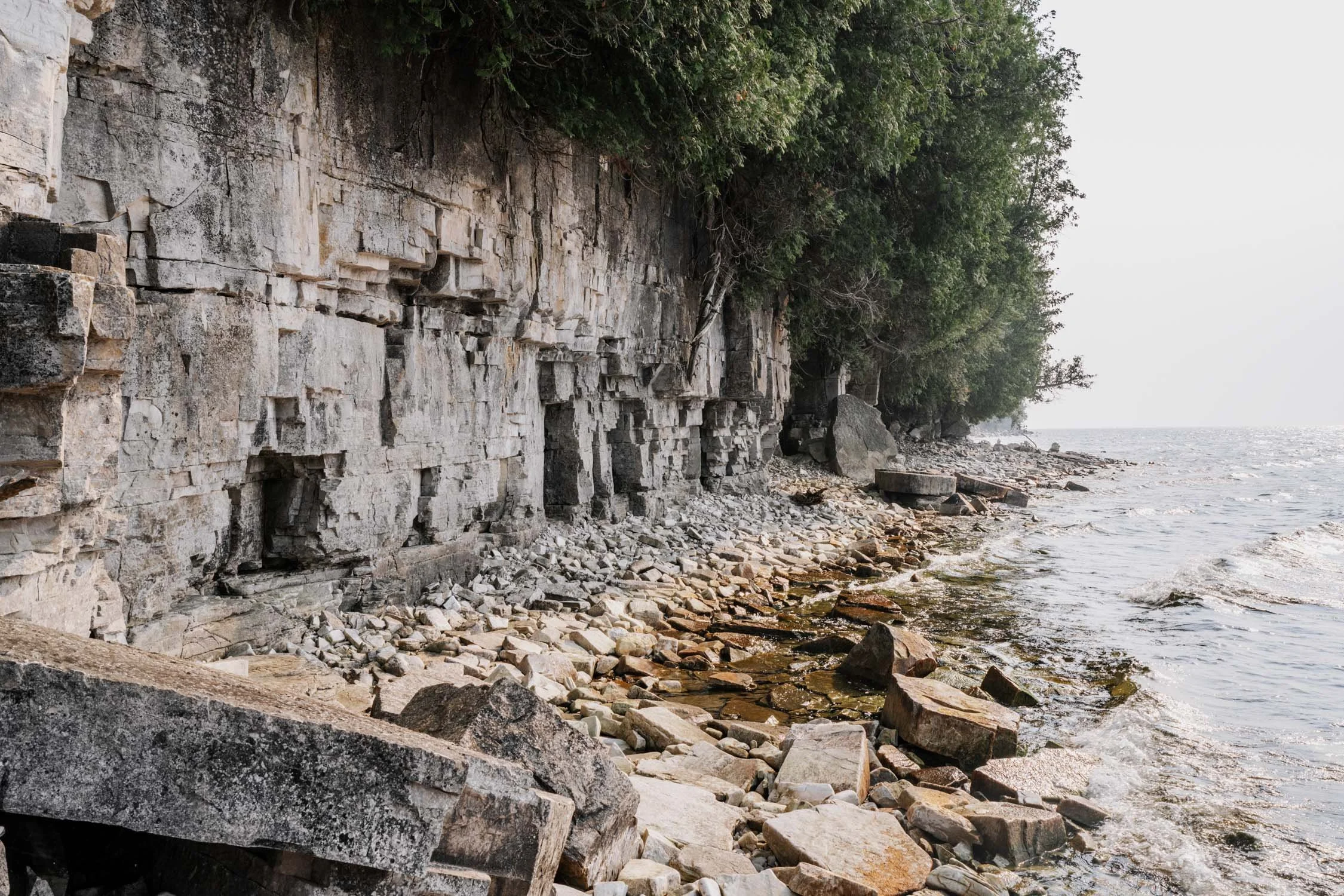 The shoreline and rocky cliffs and large beautiful rocks at door bluff.