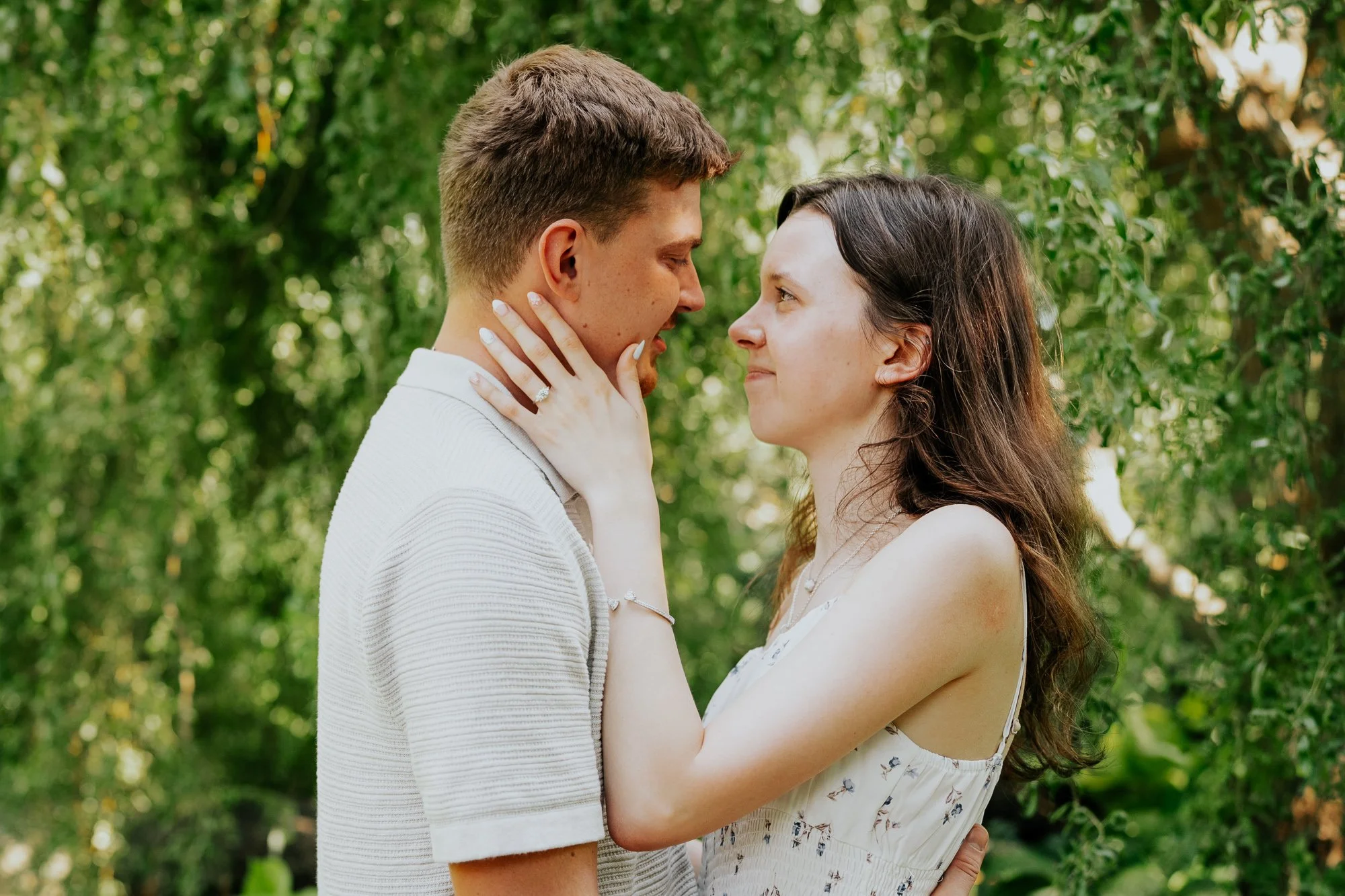 Couple embracing after a surprise proposal at Olbrich Botanical Gardens in Madison, Wisconsin.