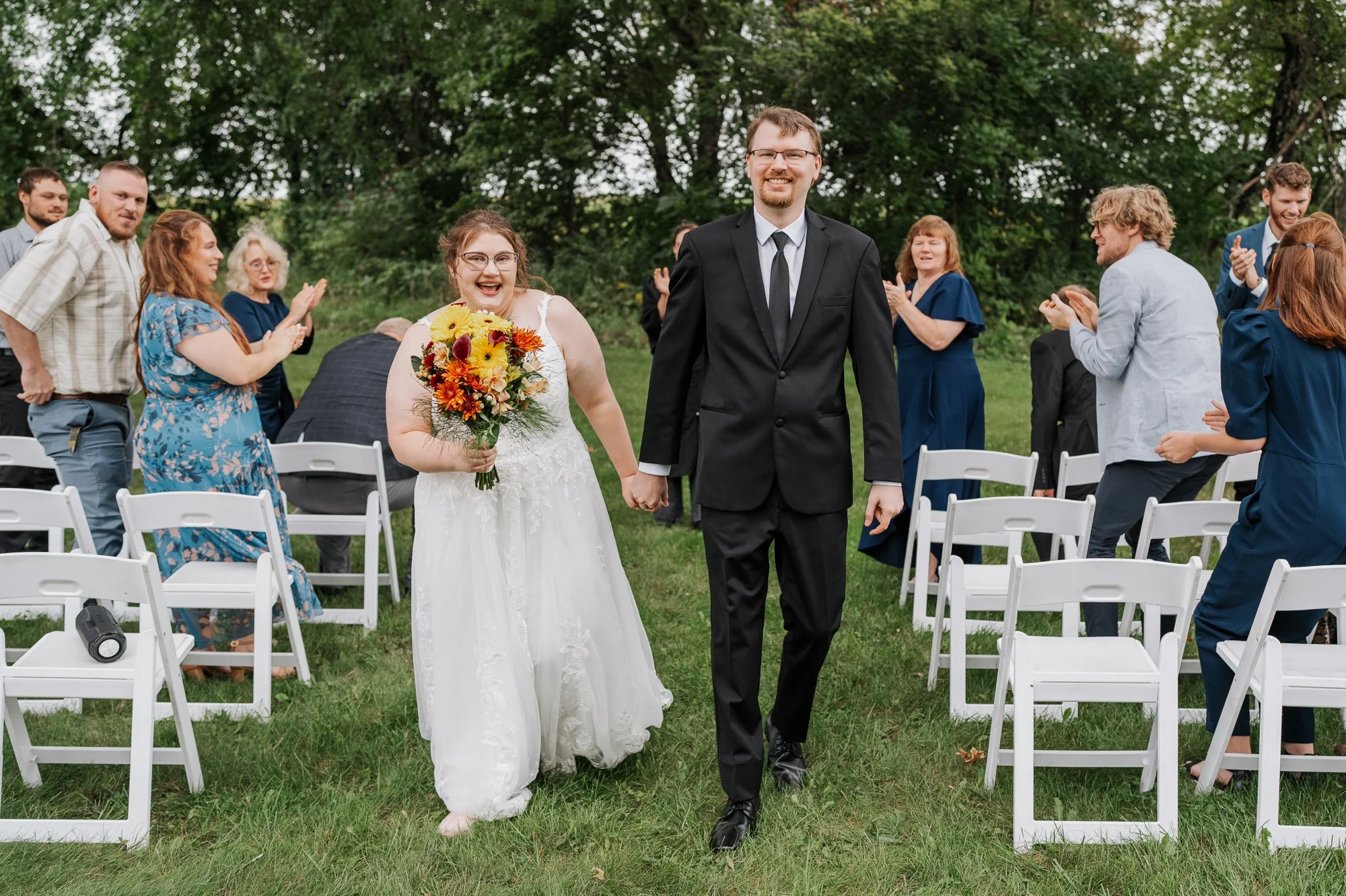 Bride and groom walking down isle after their intimate Madison wedding