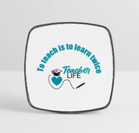 A white square sticker with rounded edges displays the quote 'To teach is to learn twice' in blue text, along with a graphic of a black graduation cap, a blue heart, and the words 'Teacher Life' in blue.