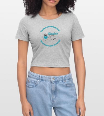 A woman wearing a light gray crop top t-shirt with a blue logo and text, paired with light blue high-waisted jeans.