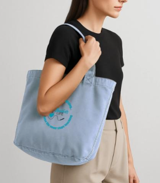 Woman in black shirt carrying a light blue tote bag.