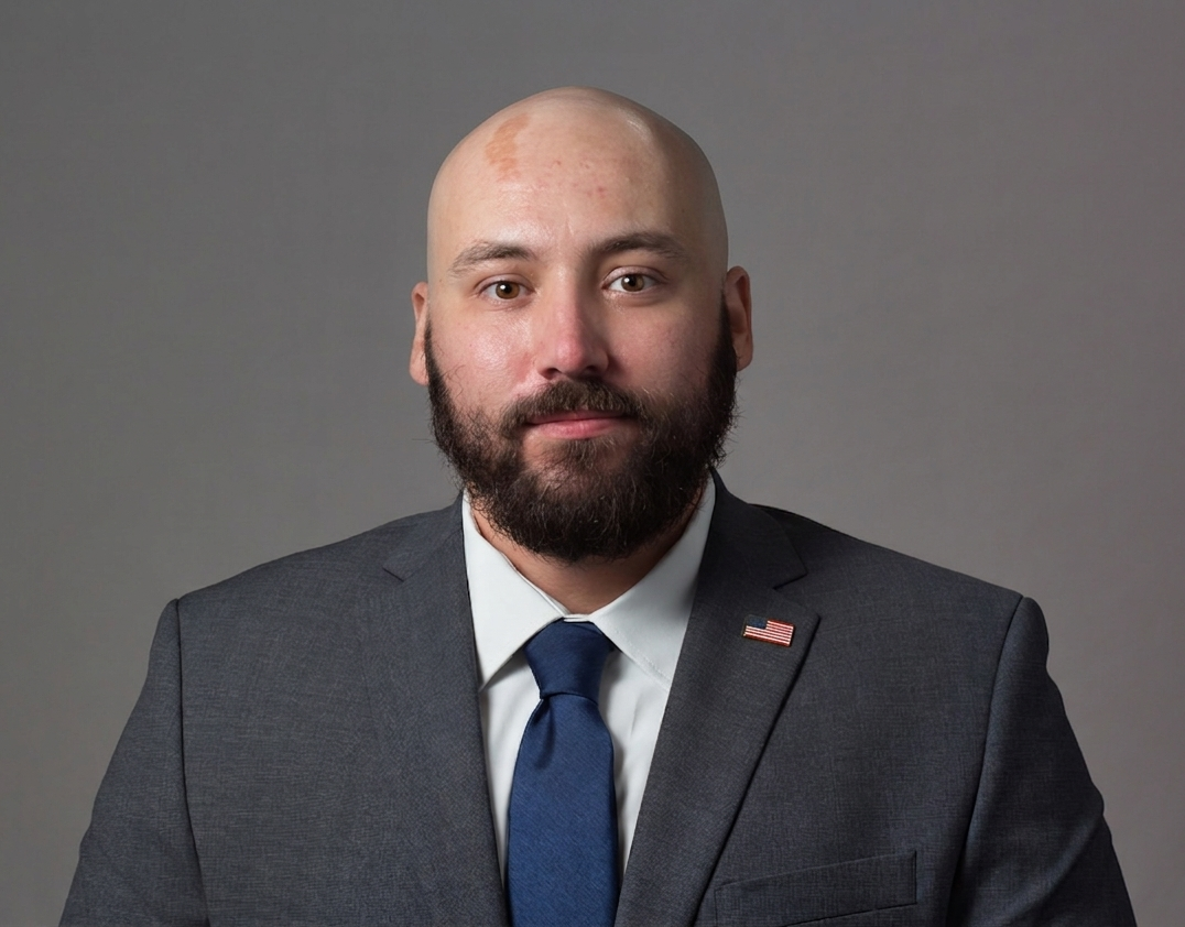 Professional headshot of Alex