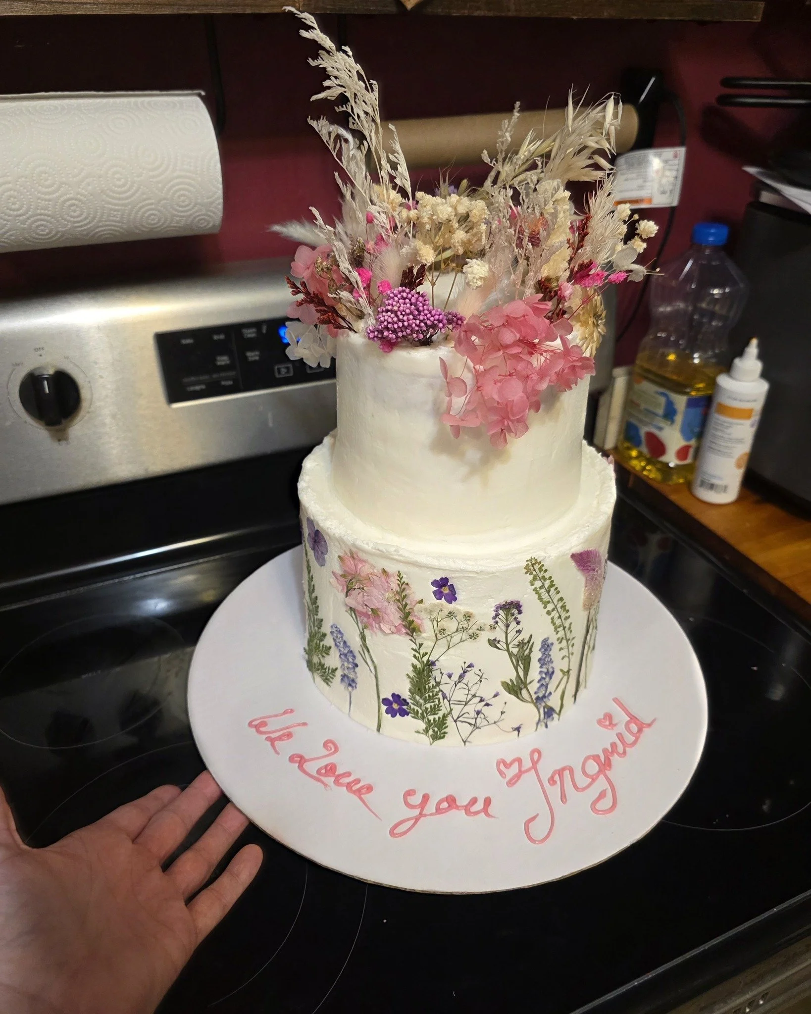 We were honored this week to create a graduation cake for a beautiful young woman as she moves on to the next chapter of her life. 🎓✨

This cake featured layers of white cake, silky smooth cream cheese frosting, and a raspberry jam filling. It was d
