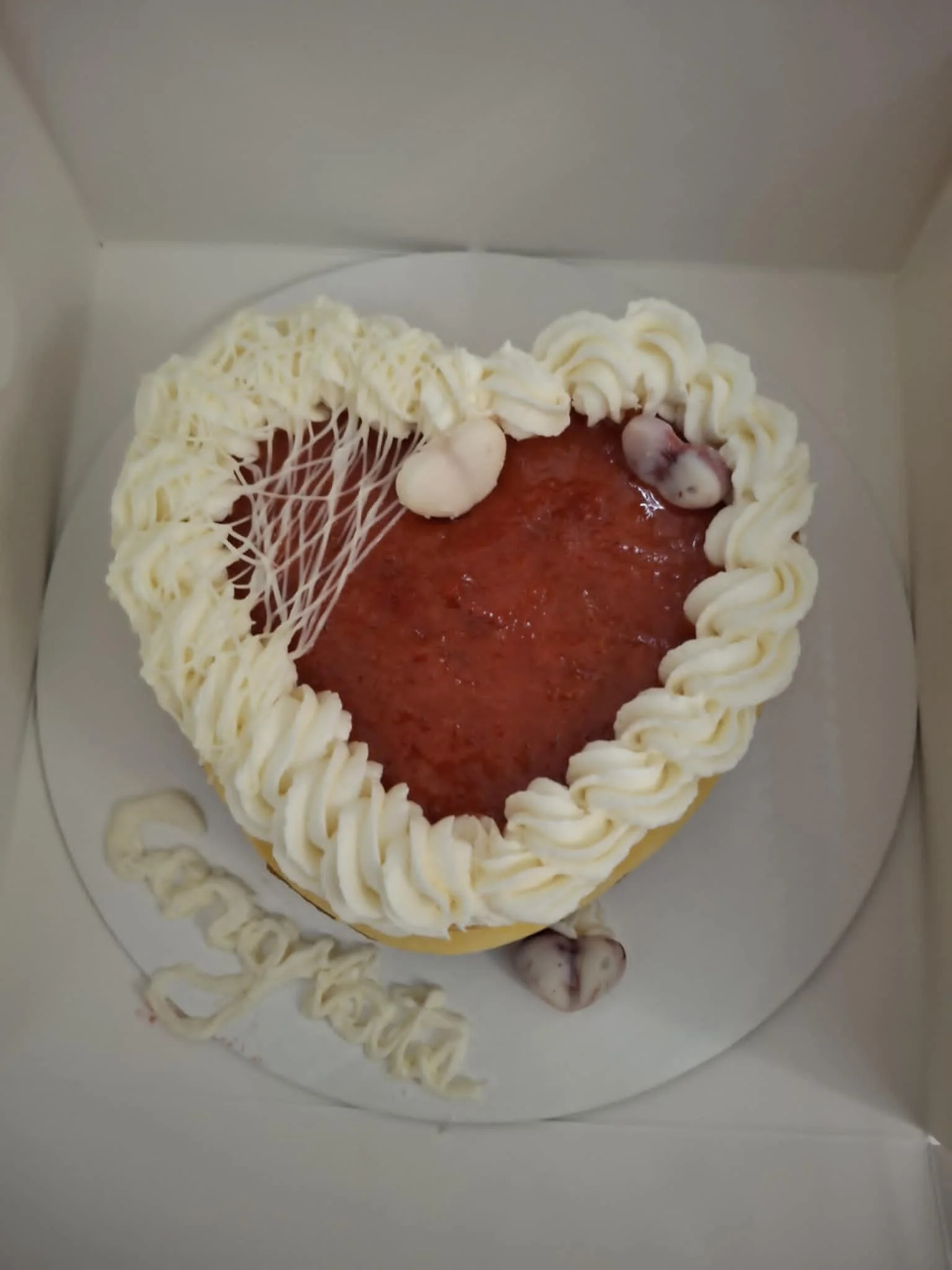 Heart shaped cake with strawberry topping