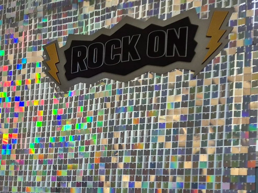 Wooden and PLA sign that says "ROCK ON" with lightning bolts on either side