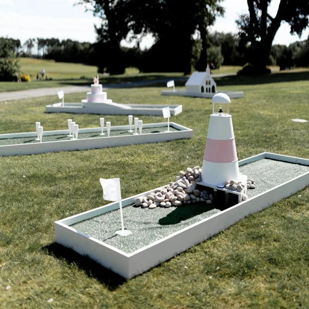 Stylish mini golf course set up on a lawn at a wedding