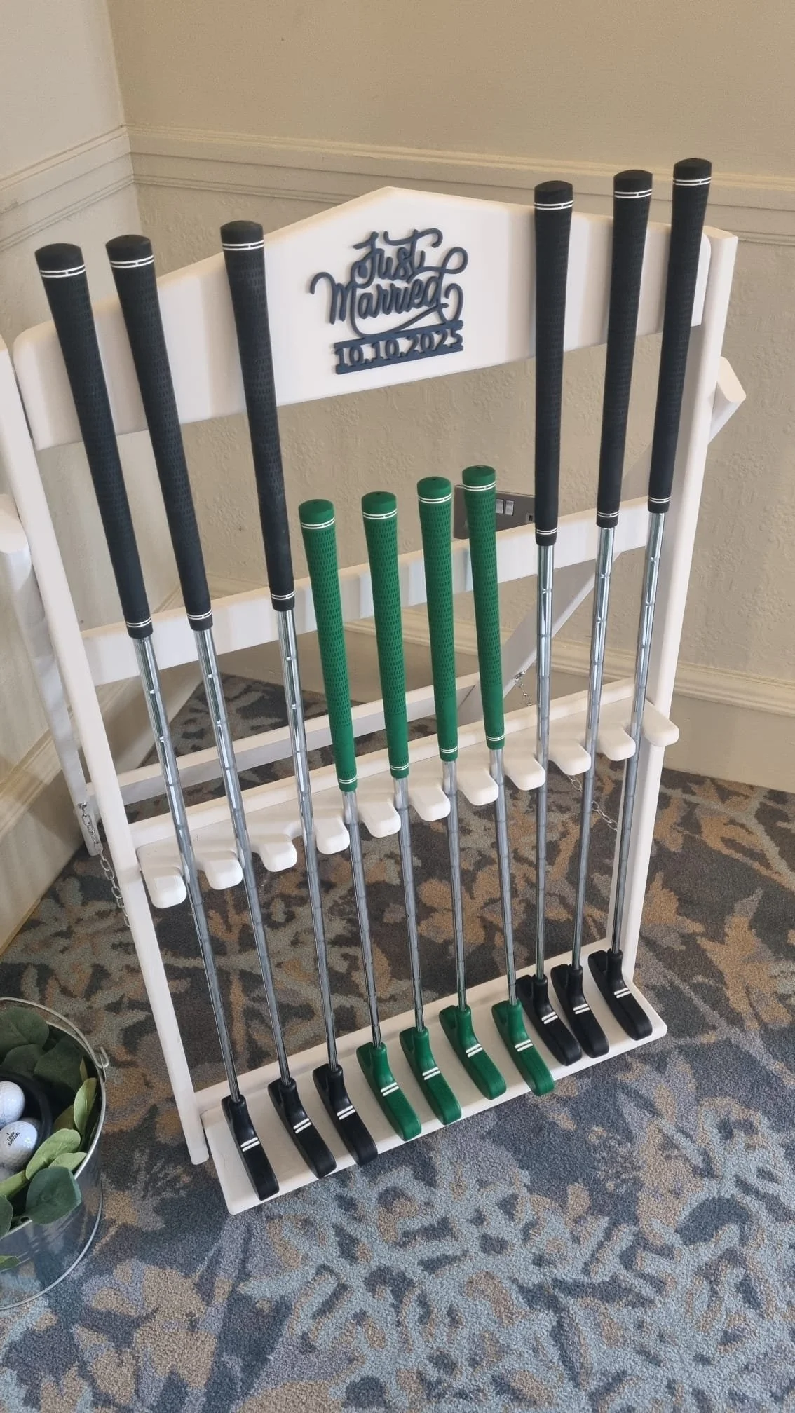 Golf clubs organized on a white rack with a 