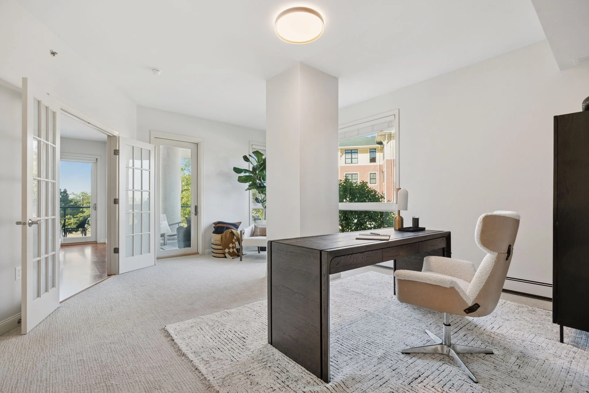 Home office with a window view of a building.