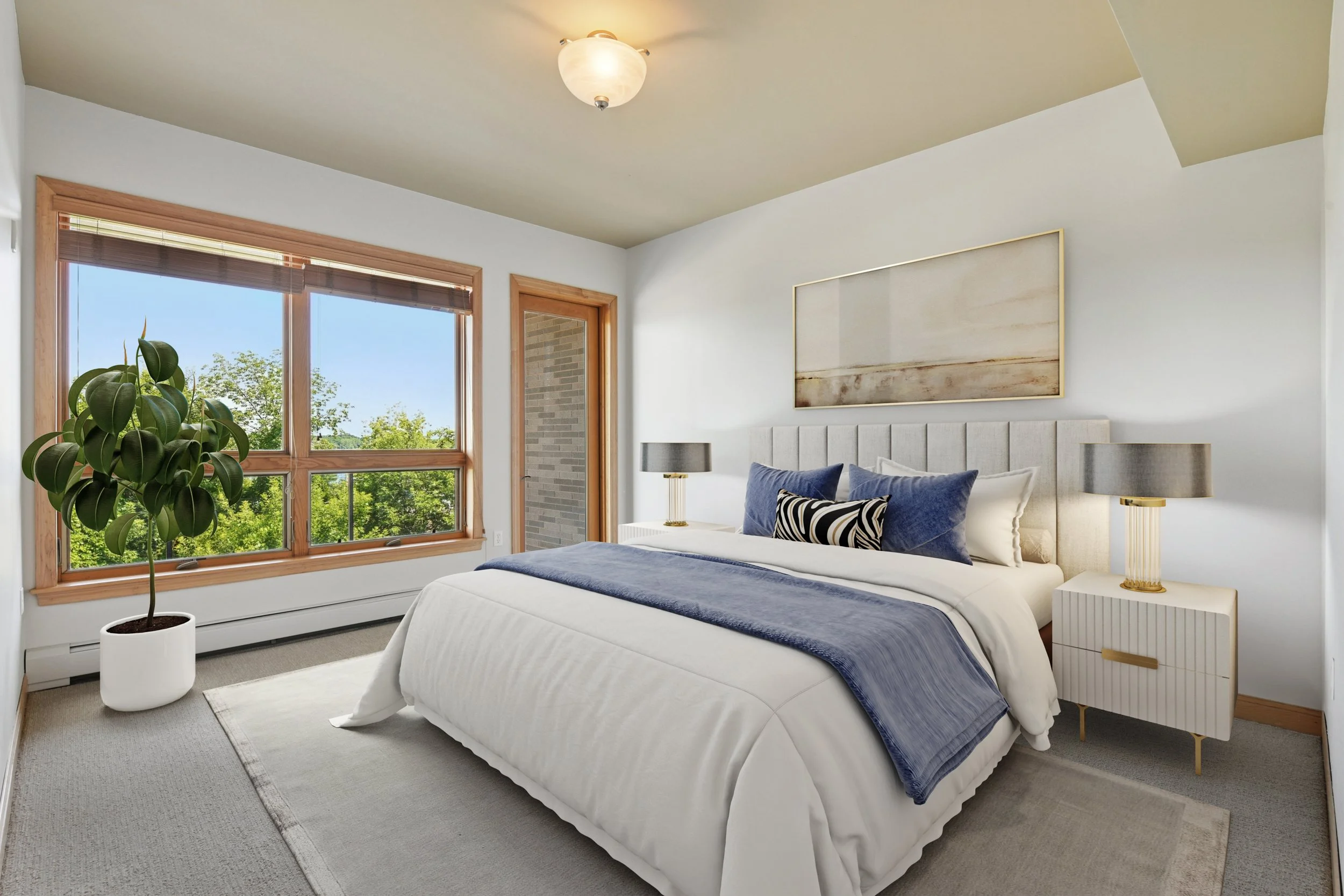 A bedroom with a large window, white walls, and a beige ceiling.