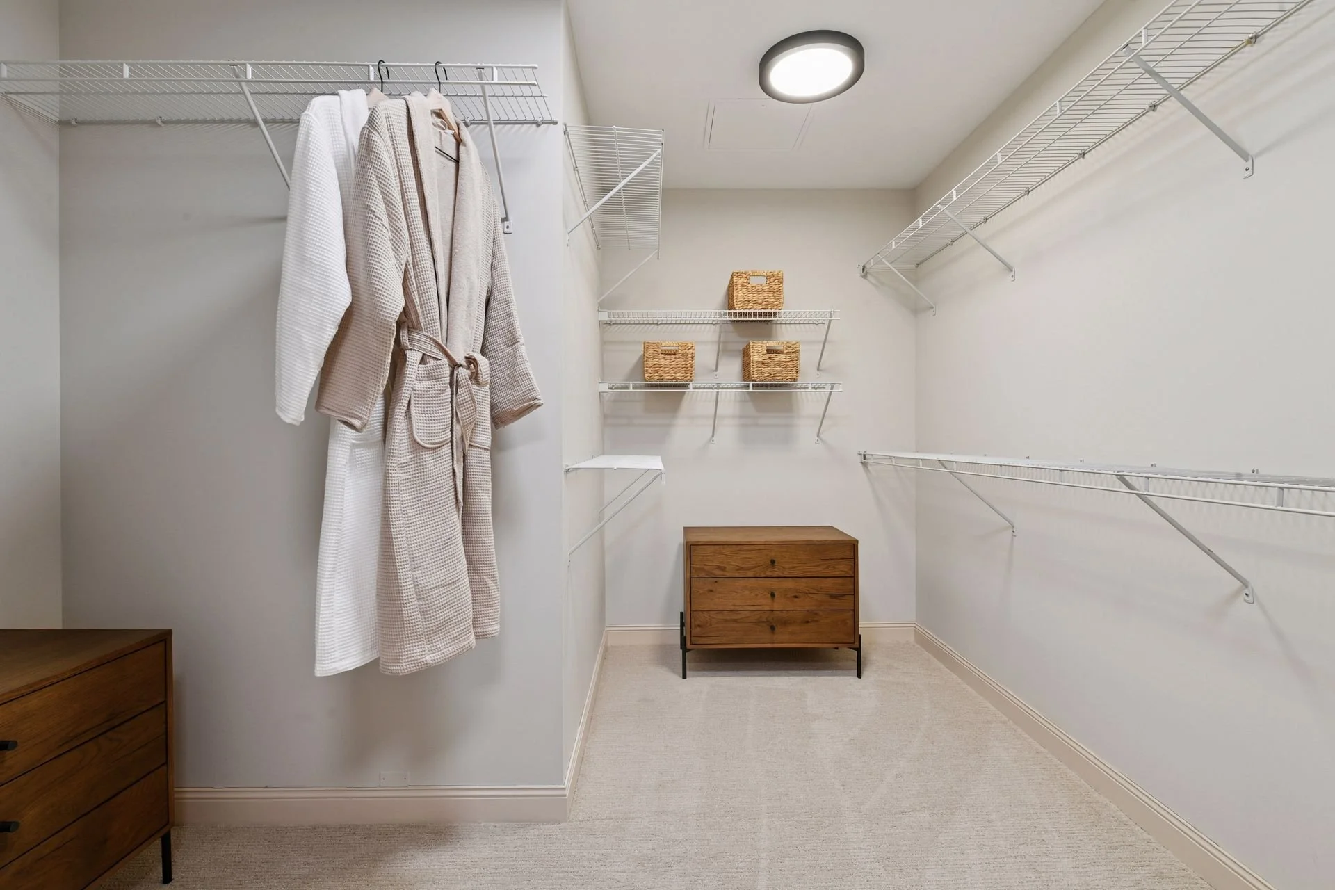 Walk-in closet with white wire shelving.