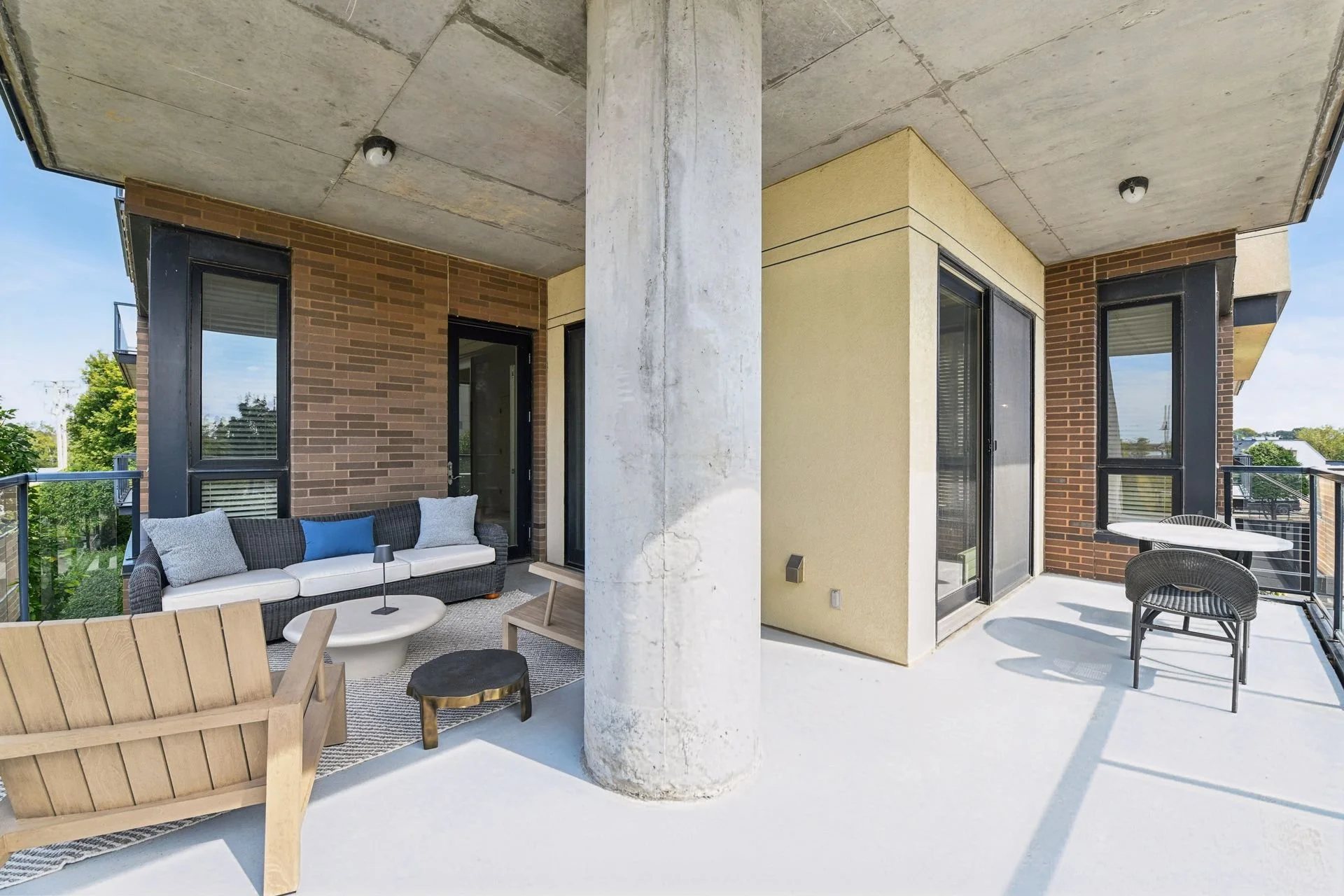 Balcony with a view of trees and neighboring buildings.