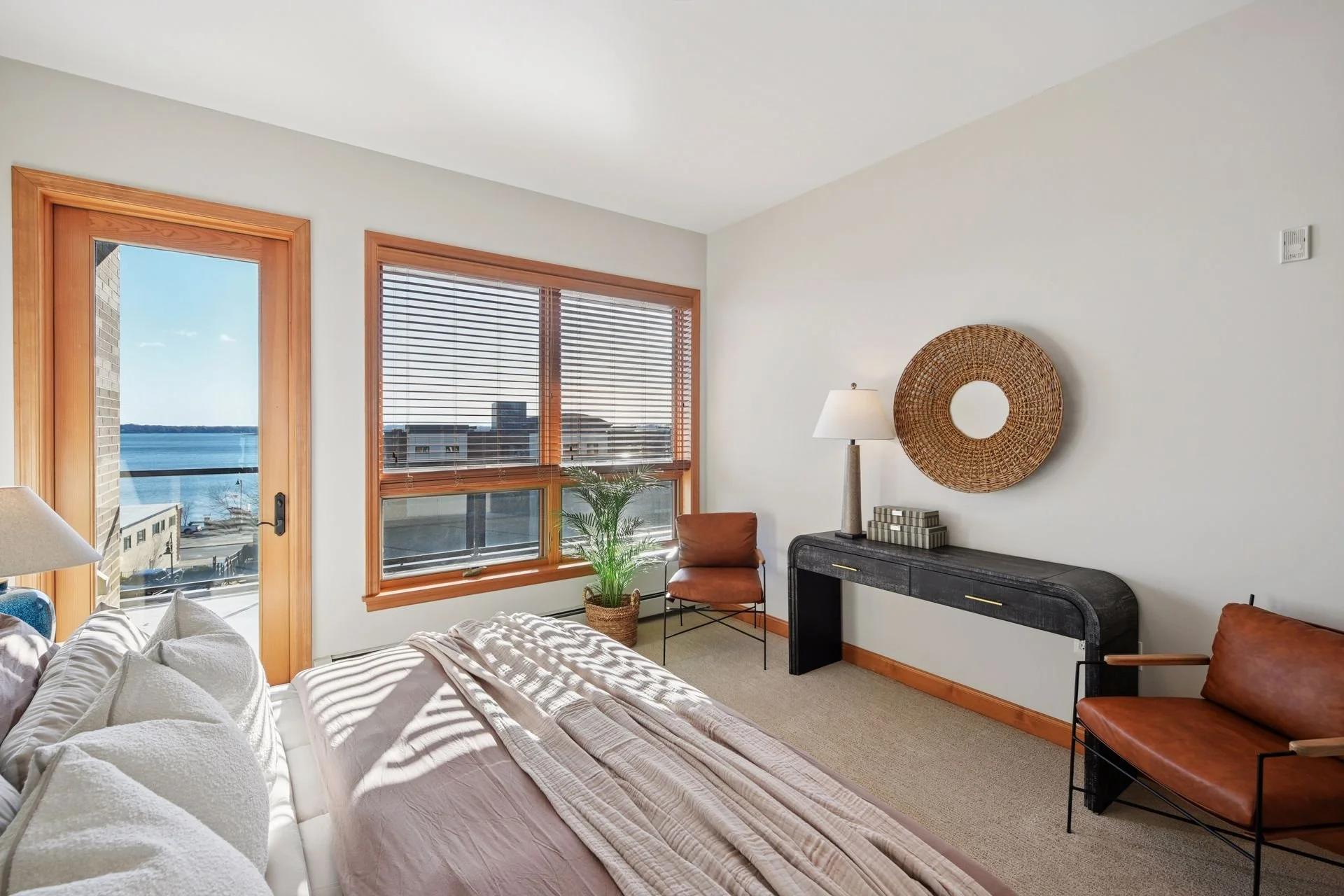 Bright bedroom with large windows overlooking Lake Minnetonka.