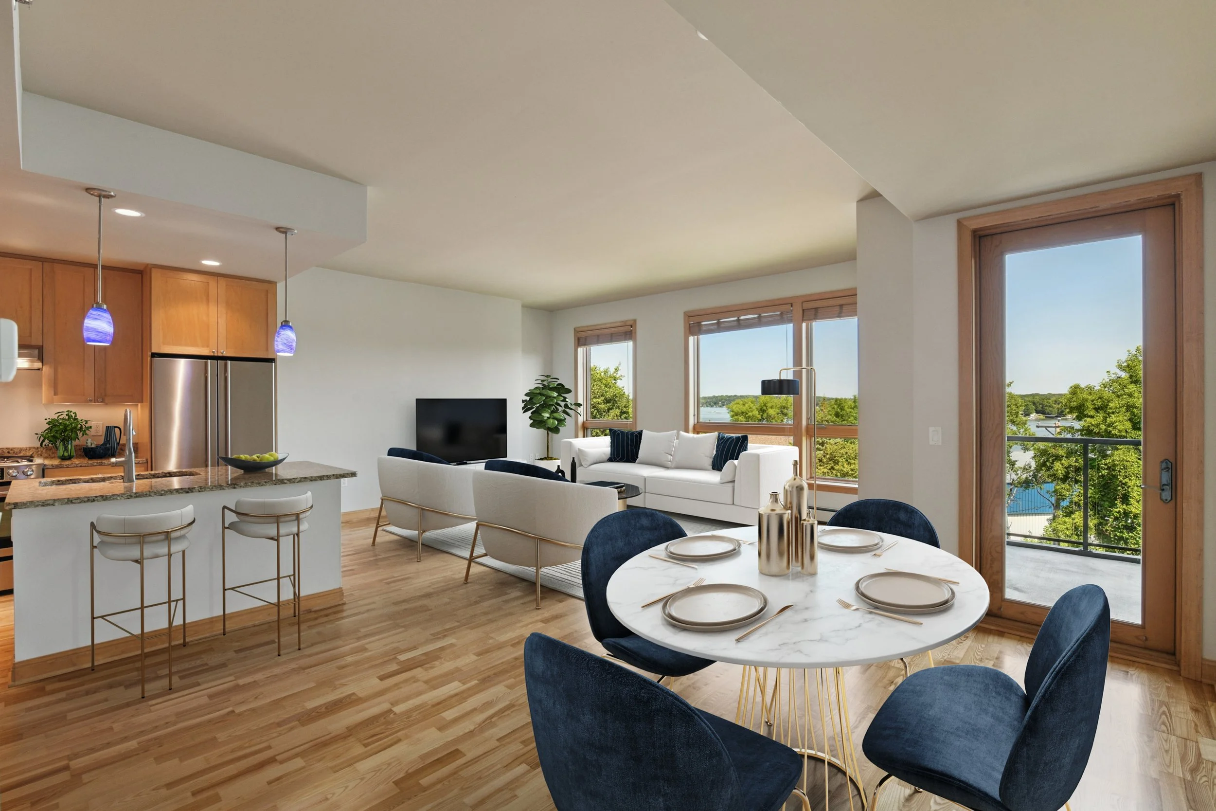 Open-concept living and dining area with wood flooring, a kitchen island, and large windows with a view of trees and Lake Minnetonka.