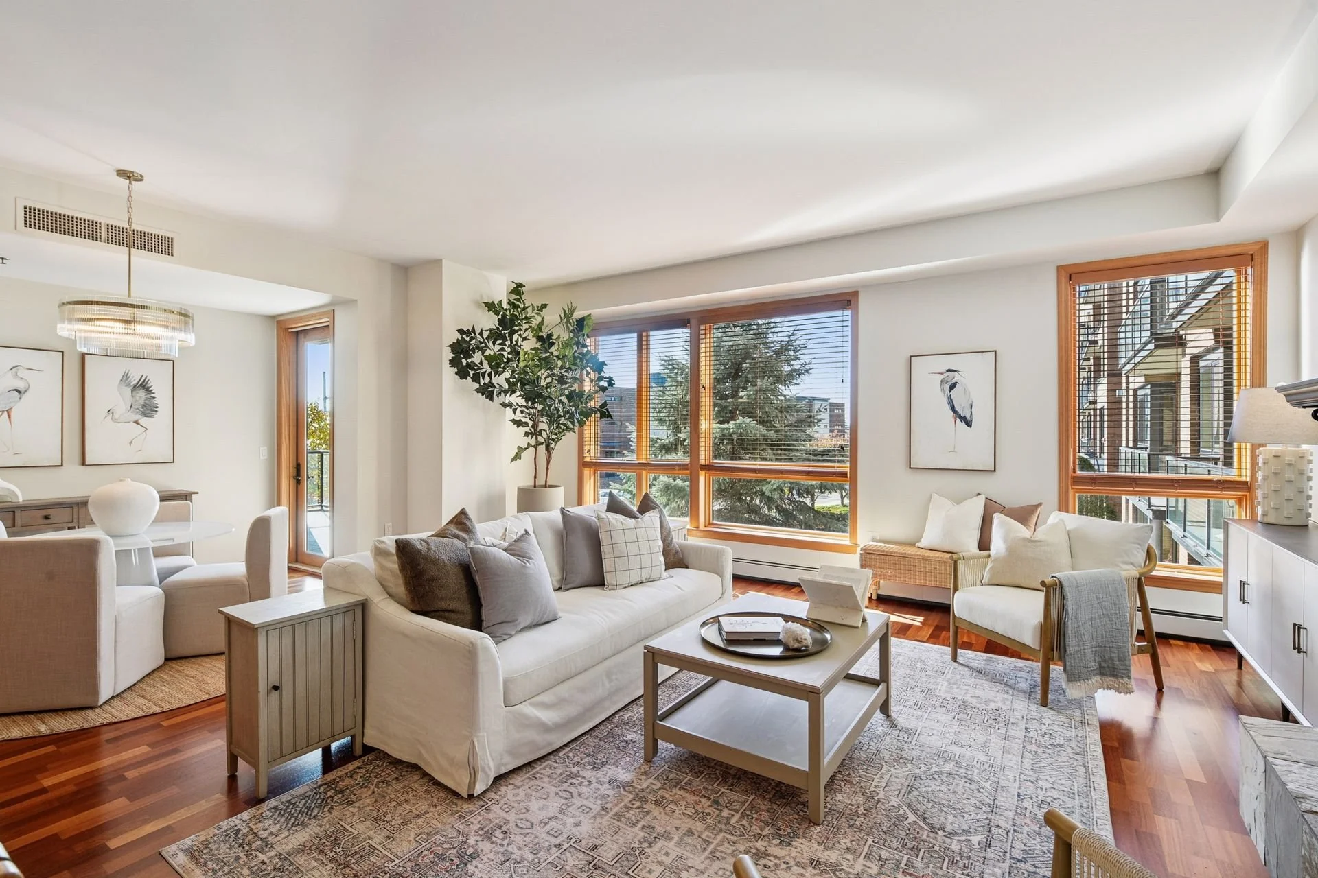 Bright living room with large windows and wooden floors.