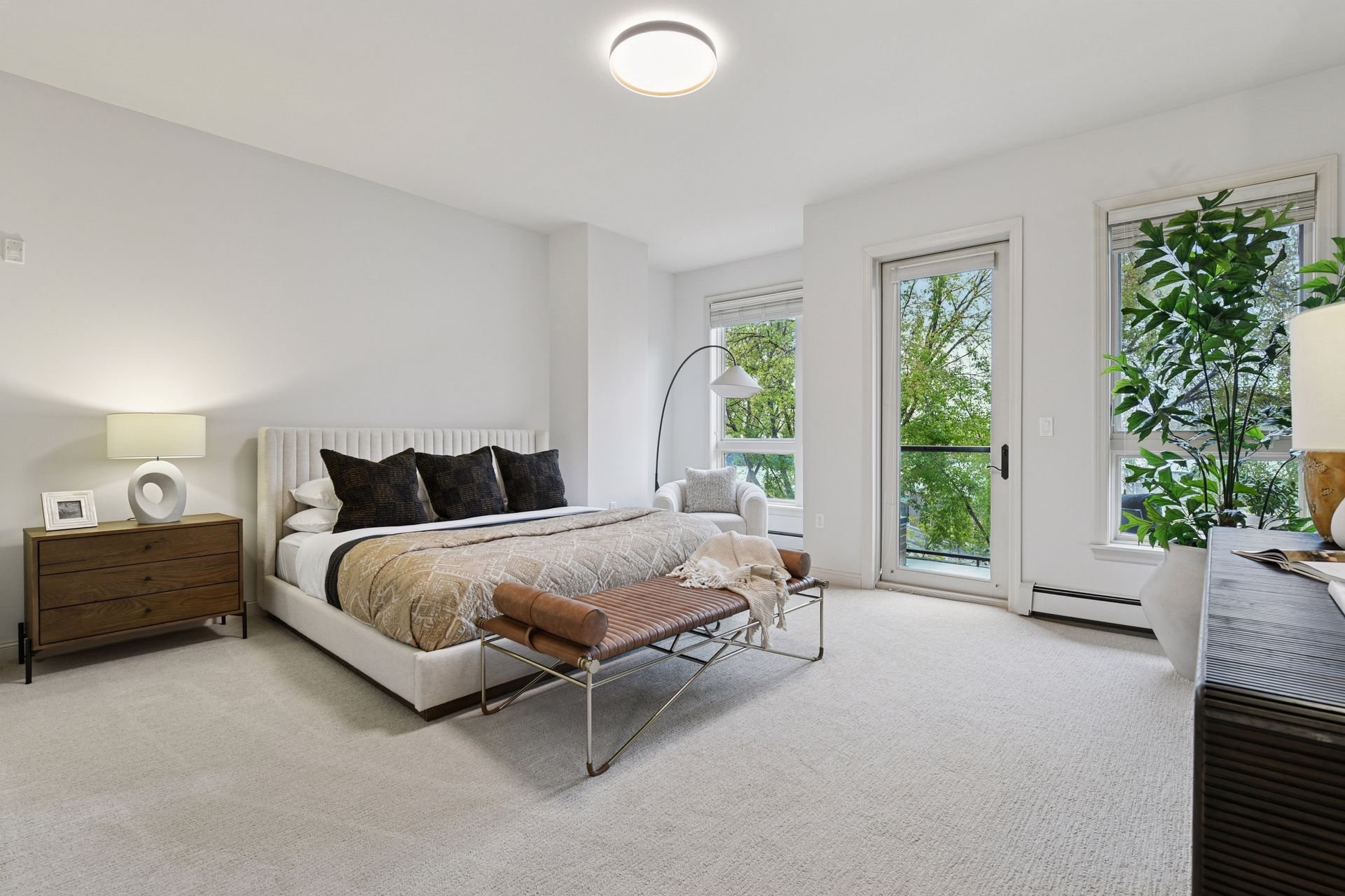 Bright bedroom with large windows.