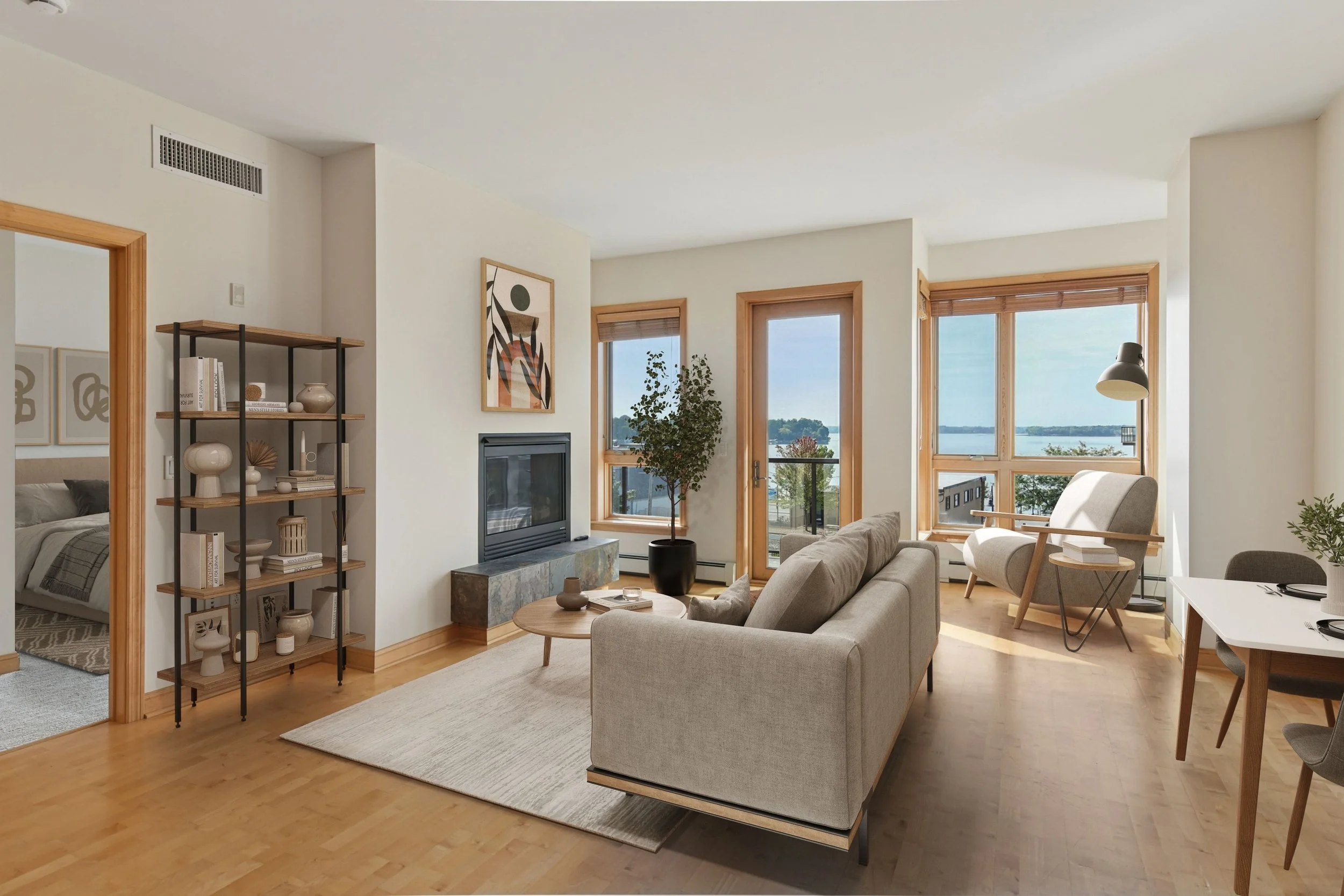 Cozy living room with large windows showing a view of Lake Minnetonka and a fireplace.