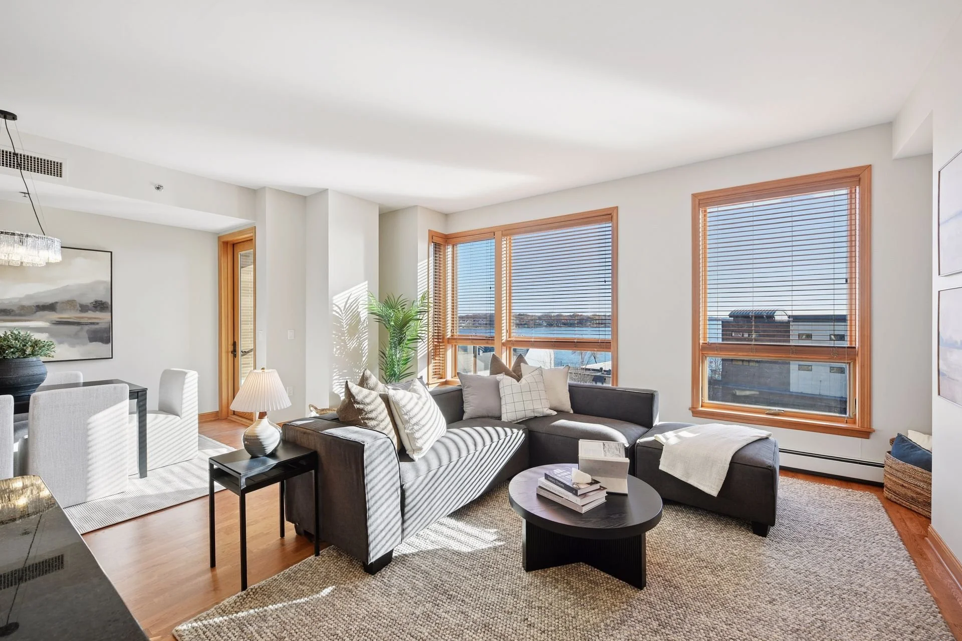 Living room with large windows and hardwood floors.