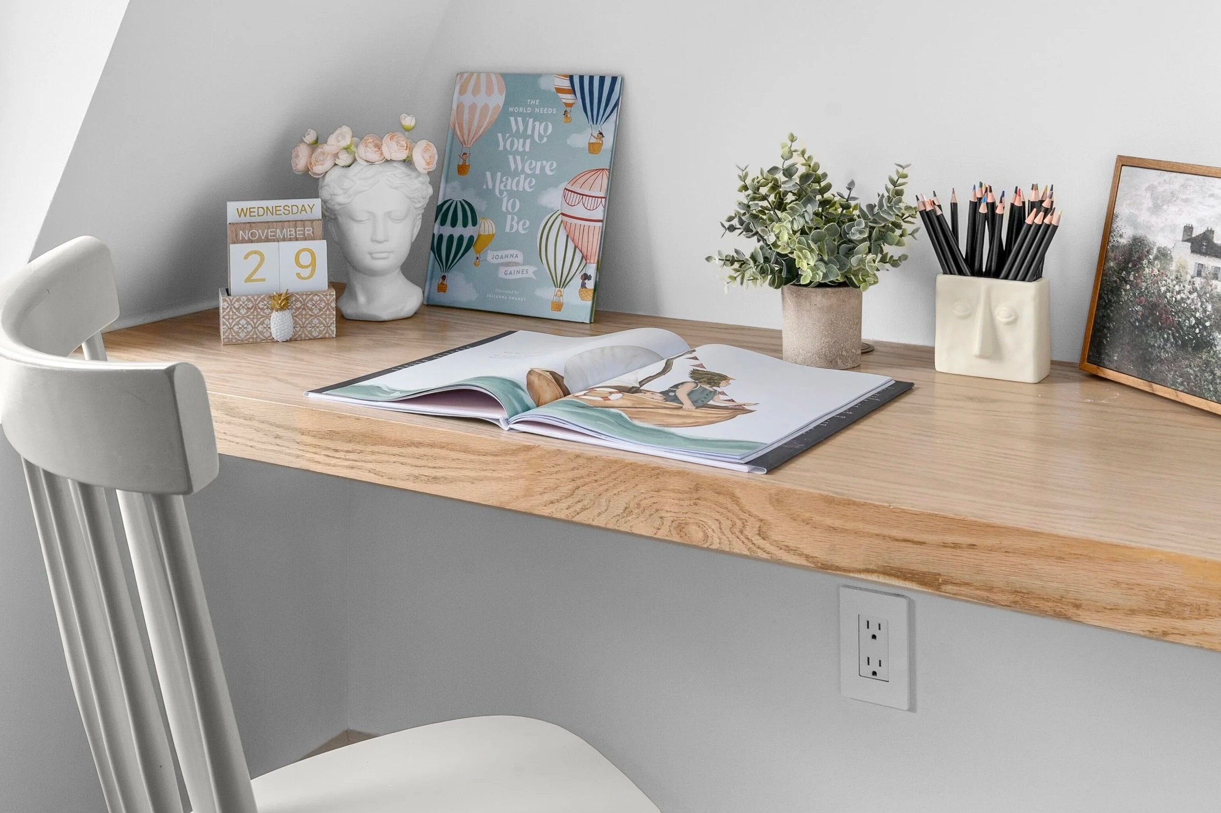 childrens desk details with illustrated books and colored pencils