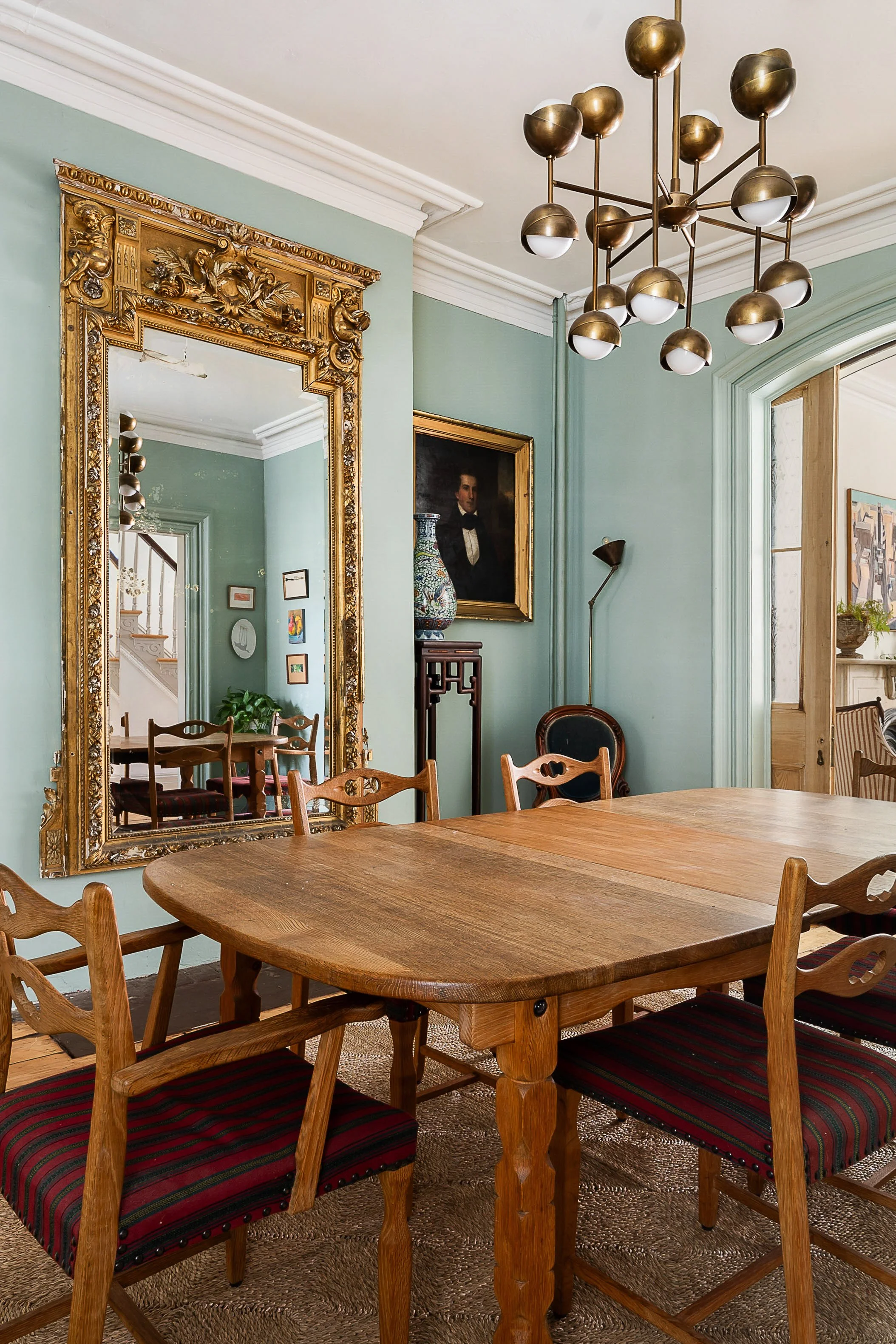 vintage living room with wood table and large gold framed mirror