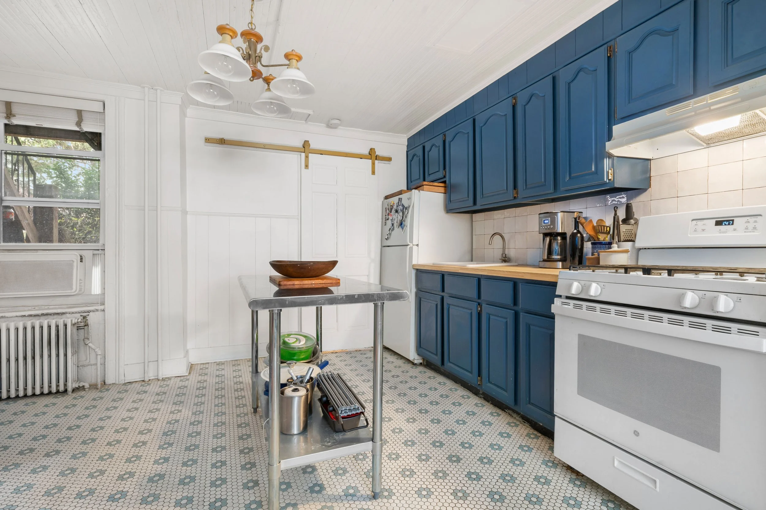 kitchen with bright blue cabinets and light blue floor tiles