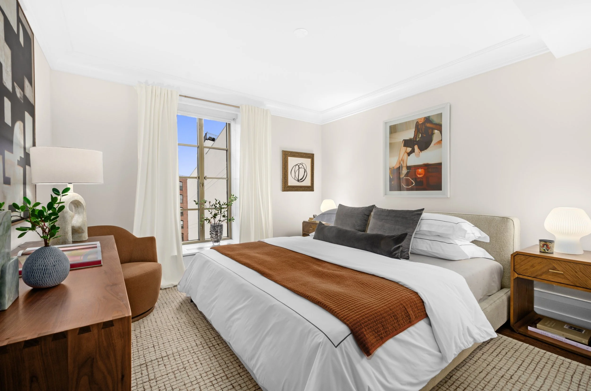 master bedroom with grey throw pillows and brown throw blanket