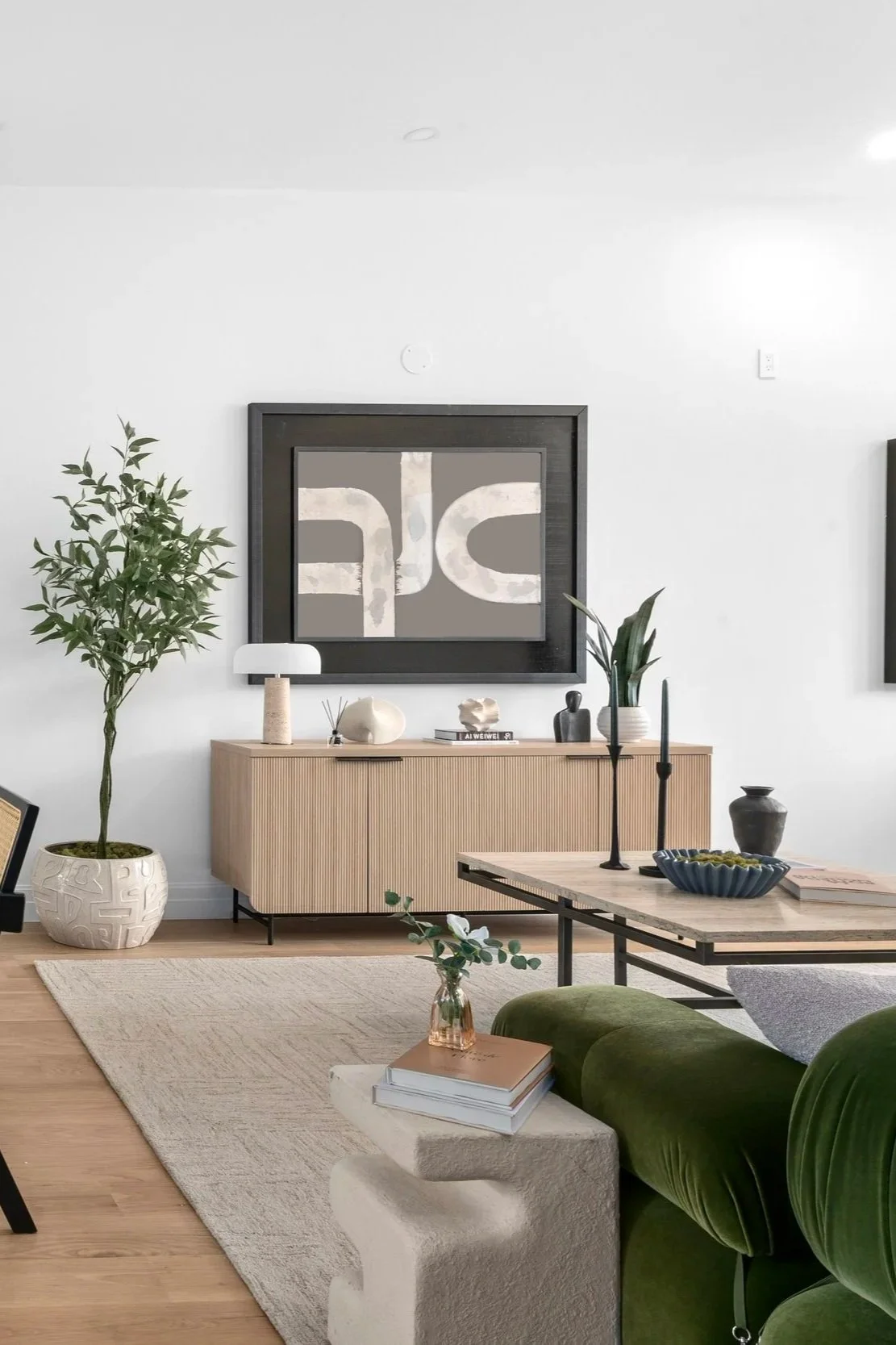 modern living room designed in neutral tones with green accents