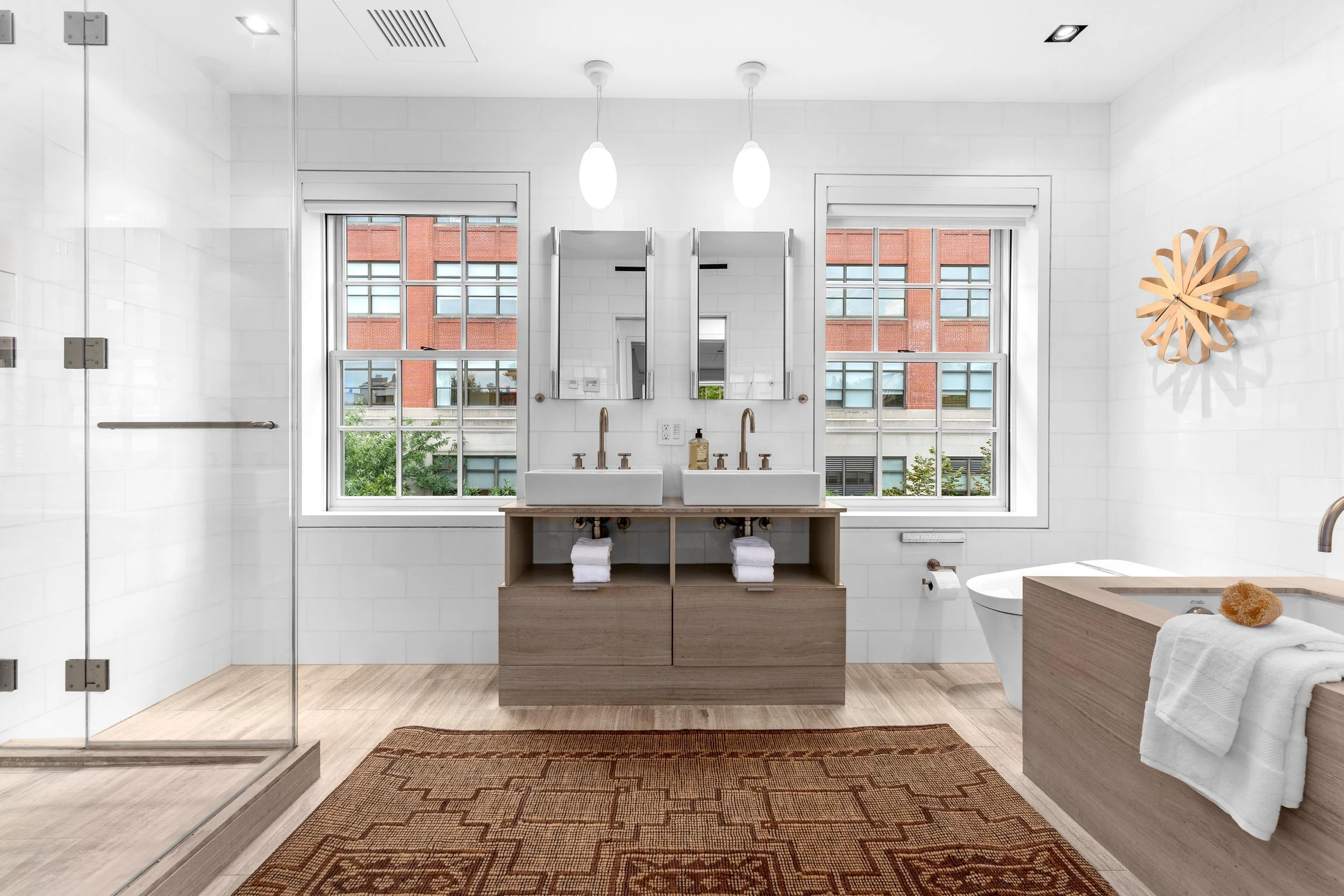 double sink master bathroom with sunny windows