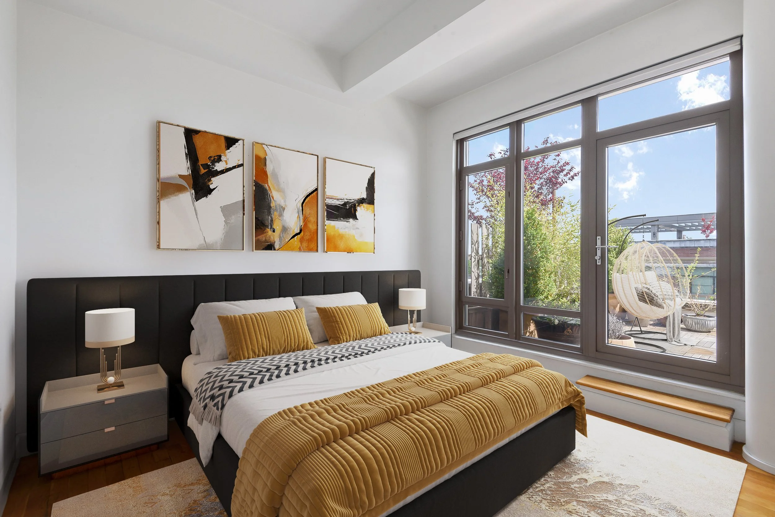 black and mustard yellow bedroom with tall windows showing greenery