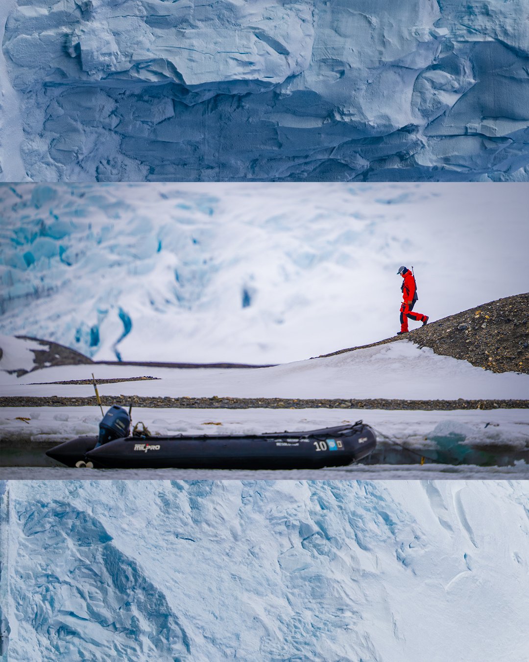 A person in red cold-weather gear walking on snow near a small inflatable boat, with a backdrop of ice and glaciers in a polar landscape.