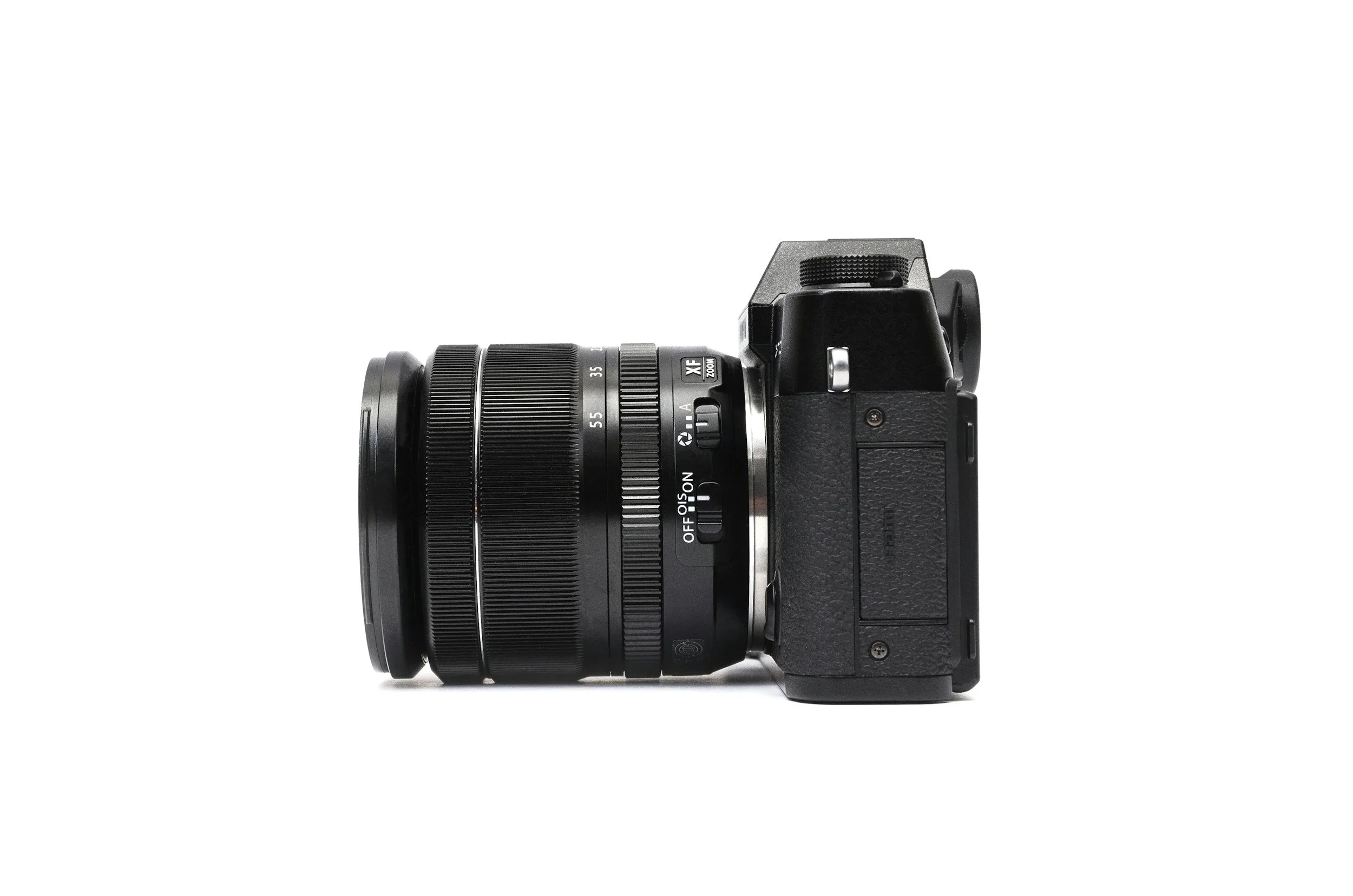 Side view of a black DSLR camera with a zoom lens attached, isolated on white background.