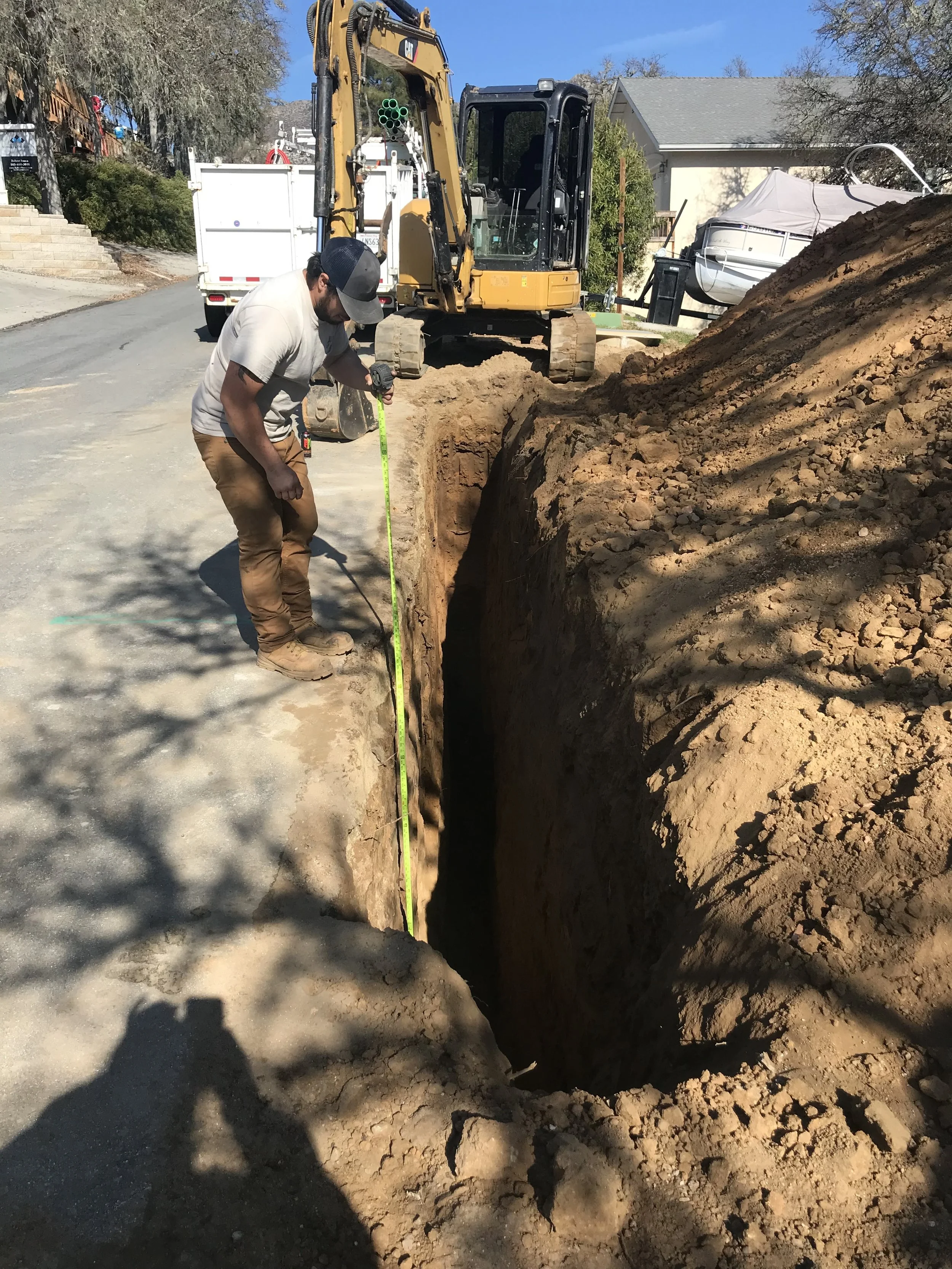 Professional measurement of an underground trench for utilities or foundation prep by Holloway Earthwork in Paso Robles