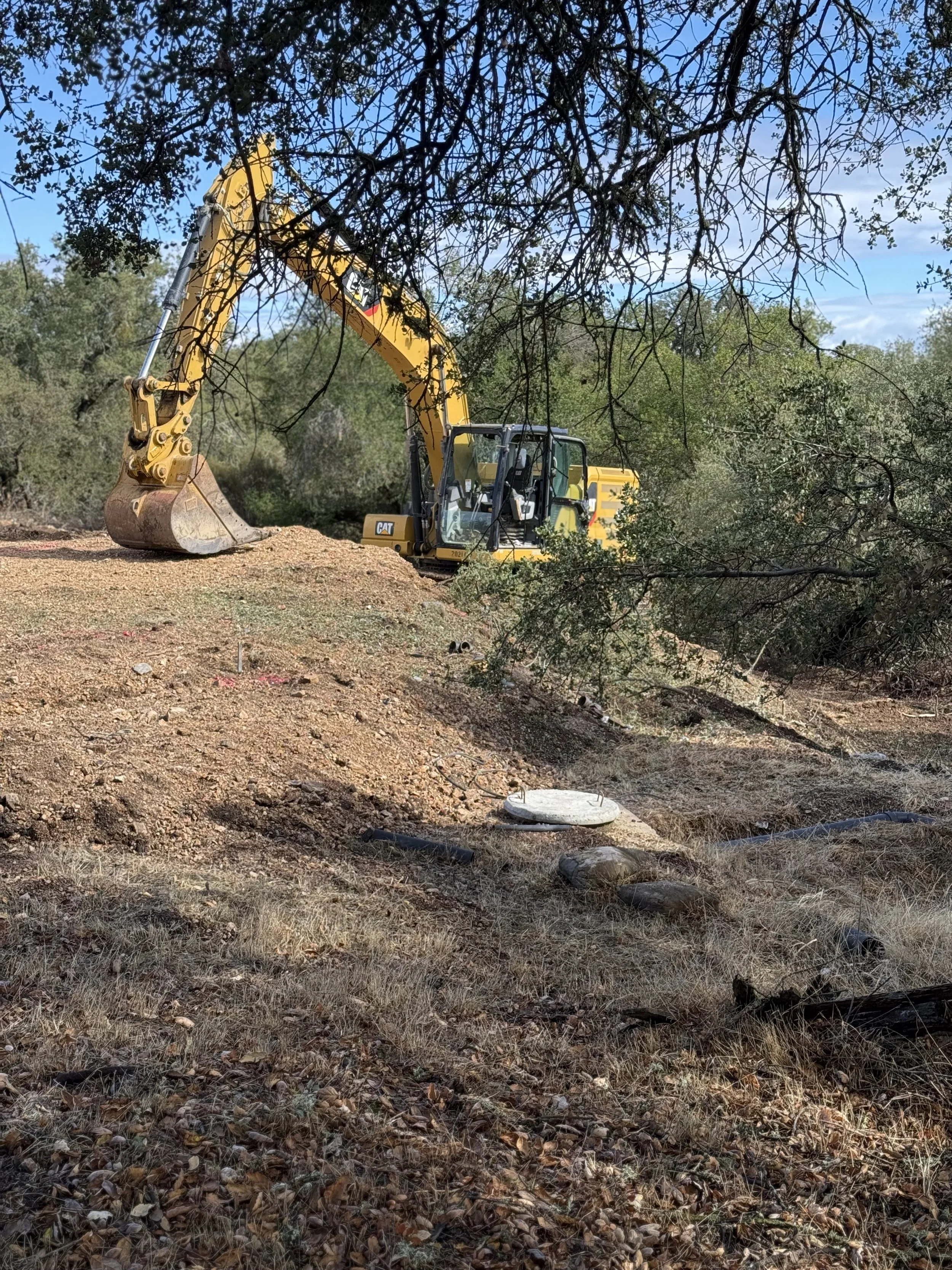 Excavator performing excavation and site preparation for construction by Holloway Earthwork in Paso Robles